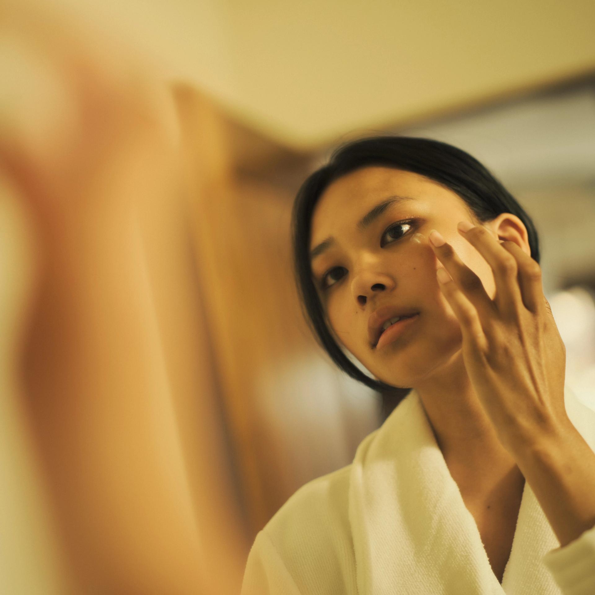 Girl apply face cream