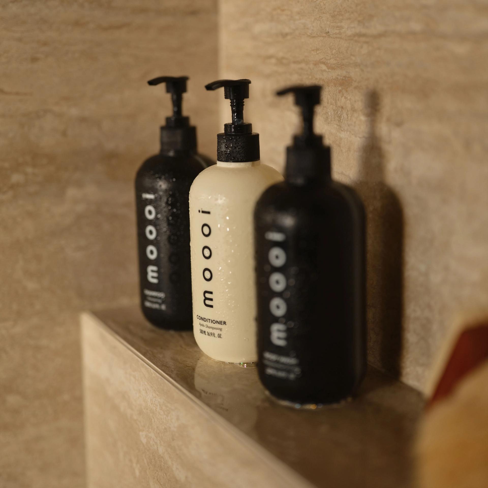 Moooi Shampoo, Conditioner, Body Wash in the shower.