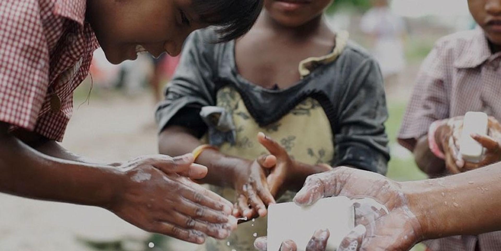 children in Africa washing their hands with bars of soap