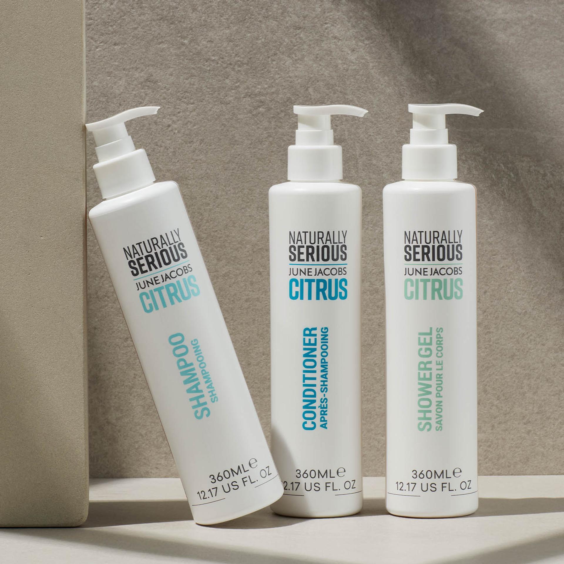 Naturally Serious Skincare Citrus Shampoo, Conditioner, and Body Wash dispensers on counter