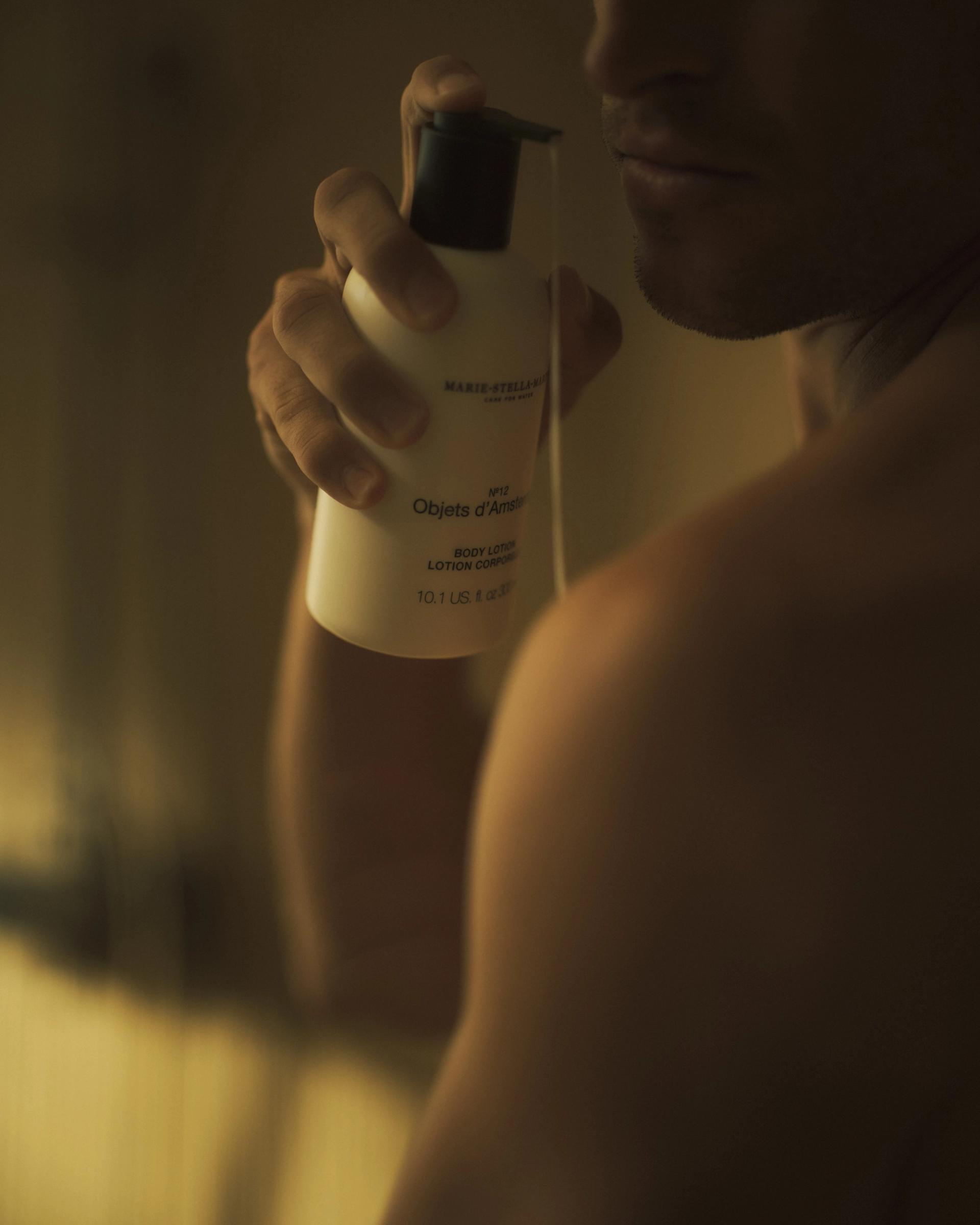 Man in shower using Marie Stella Maris Objets d'Amsterdam Body Lotion on body