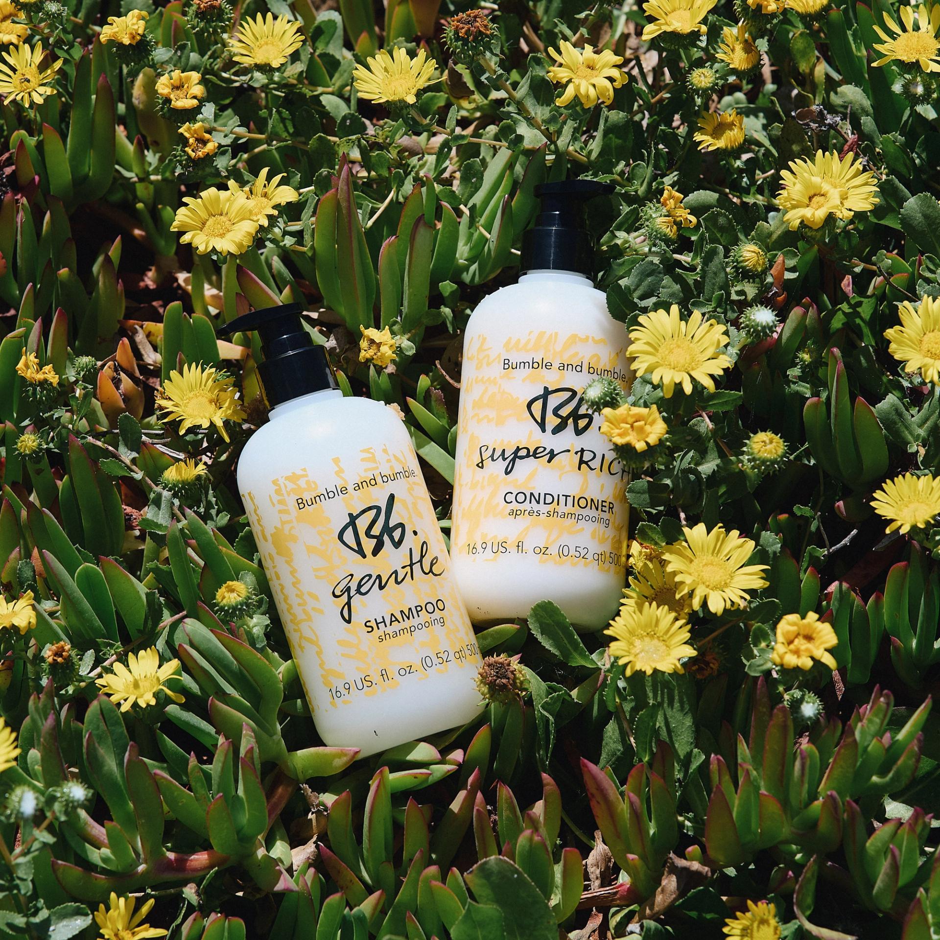 Bumble & Bumble Shampoo and Conditioner photographed in a bed of flowers
