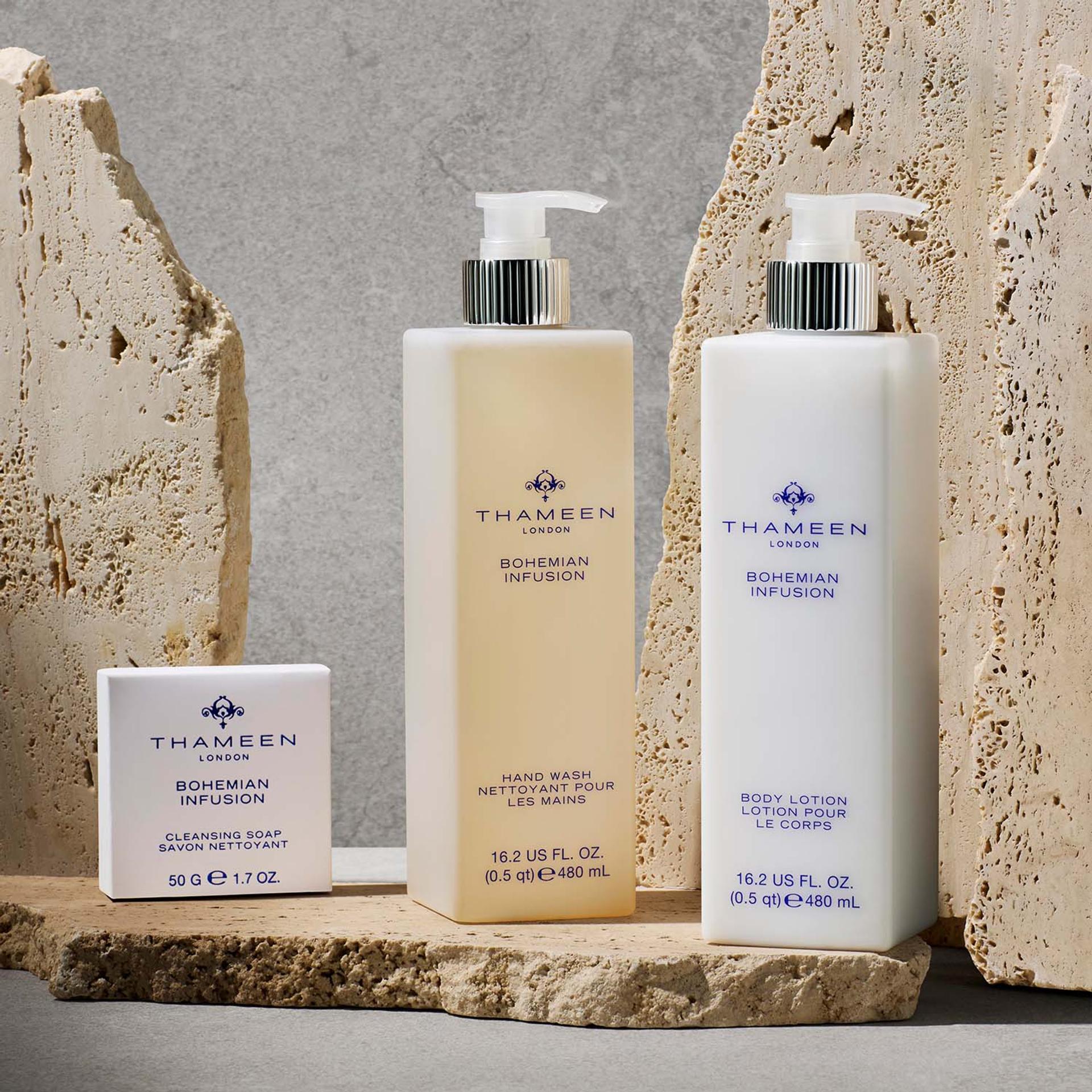 Thameen London Bohemian Infusion Hand Wash and Body Lotion dispensers and bar soap on bathroom vanity with stone