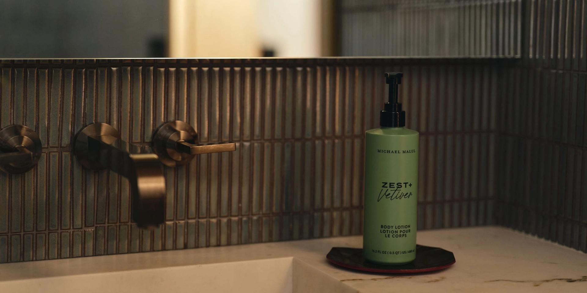 Michael Malul Body Lotion 480ml on the vanity side.