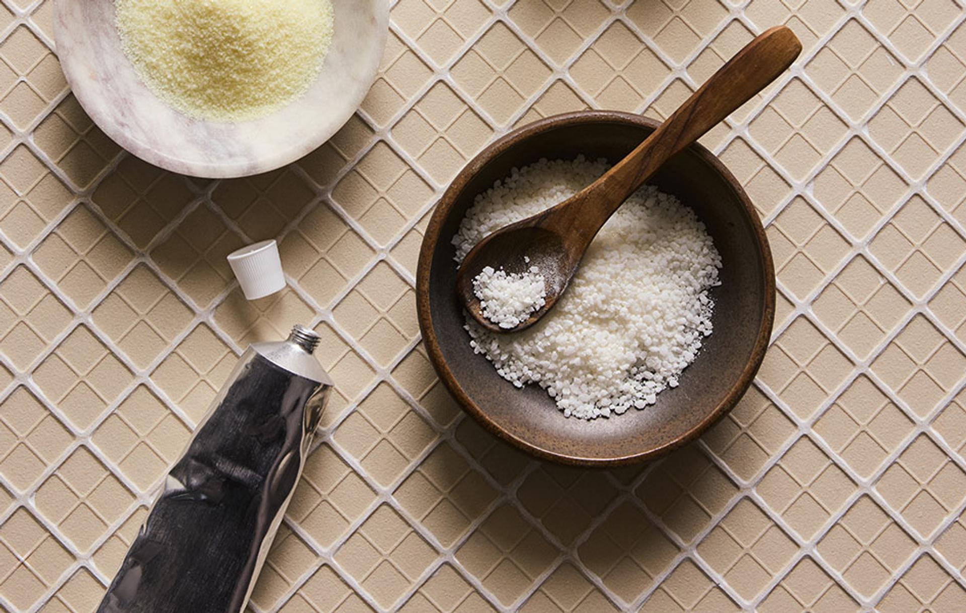 Bath products and aluminum packaging displayed on tile surface