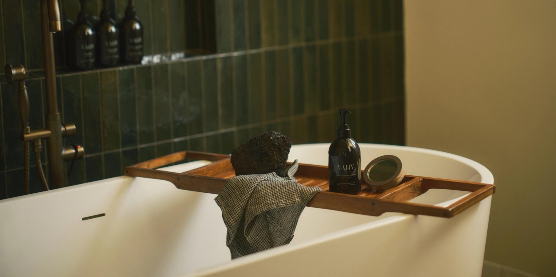 Vahy Isle of Blanc dispensers on bathroom tile shelf and bathtub tray