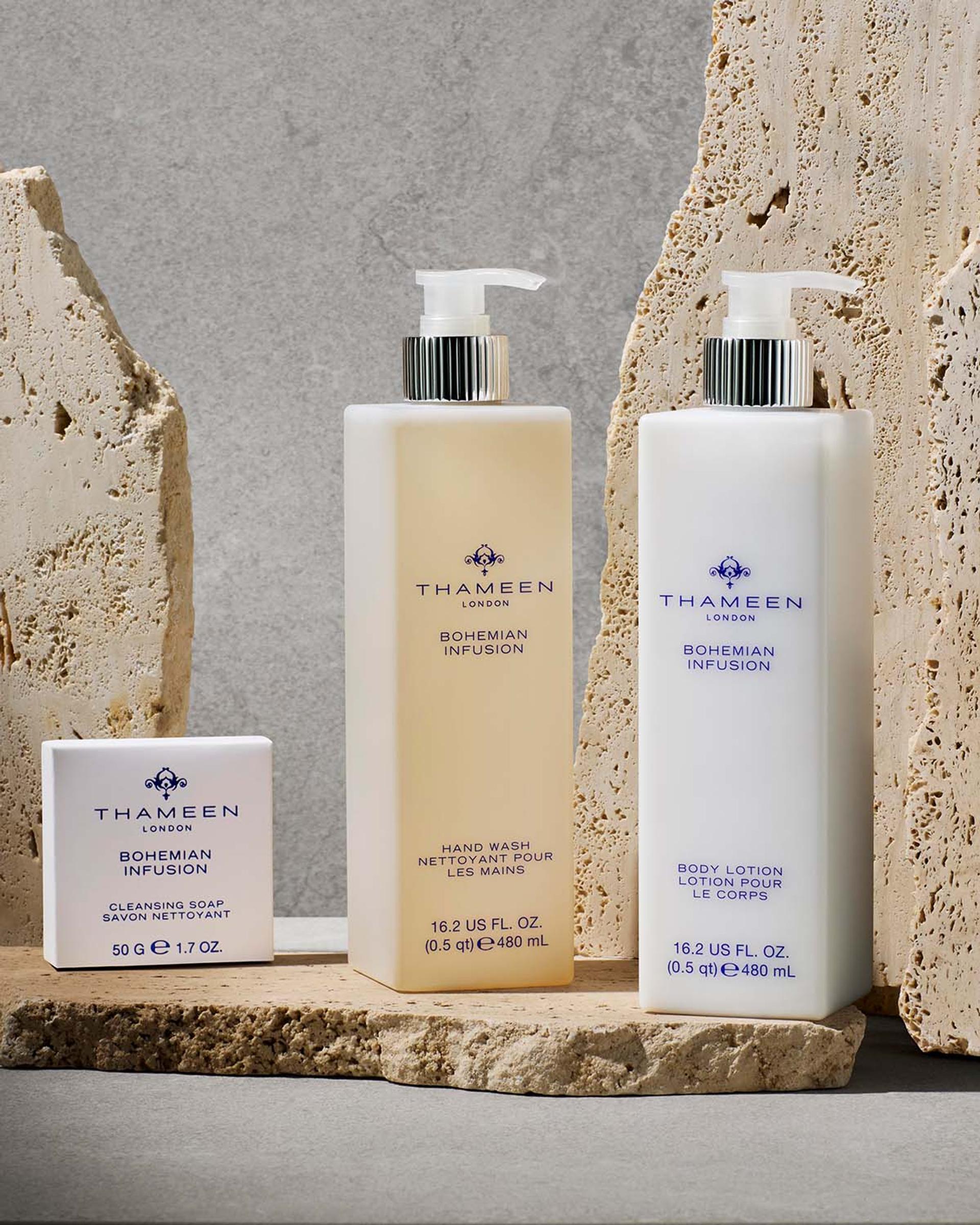 Thameen London Bohemian Infusion Hand Wash and Body Lotion dispensers and bar soap on bathroom vanity with stone