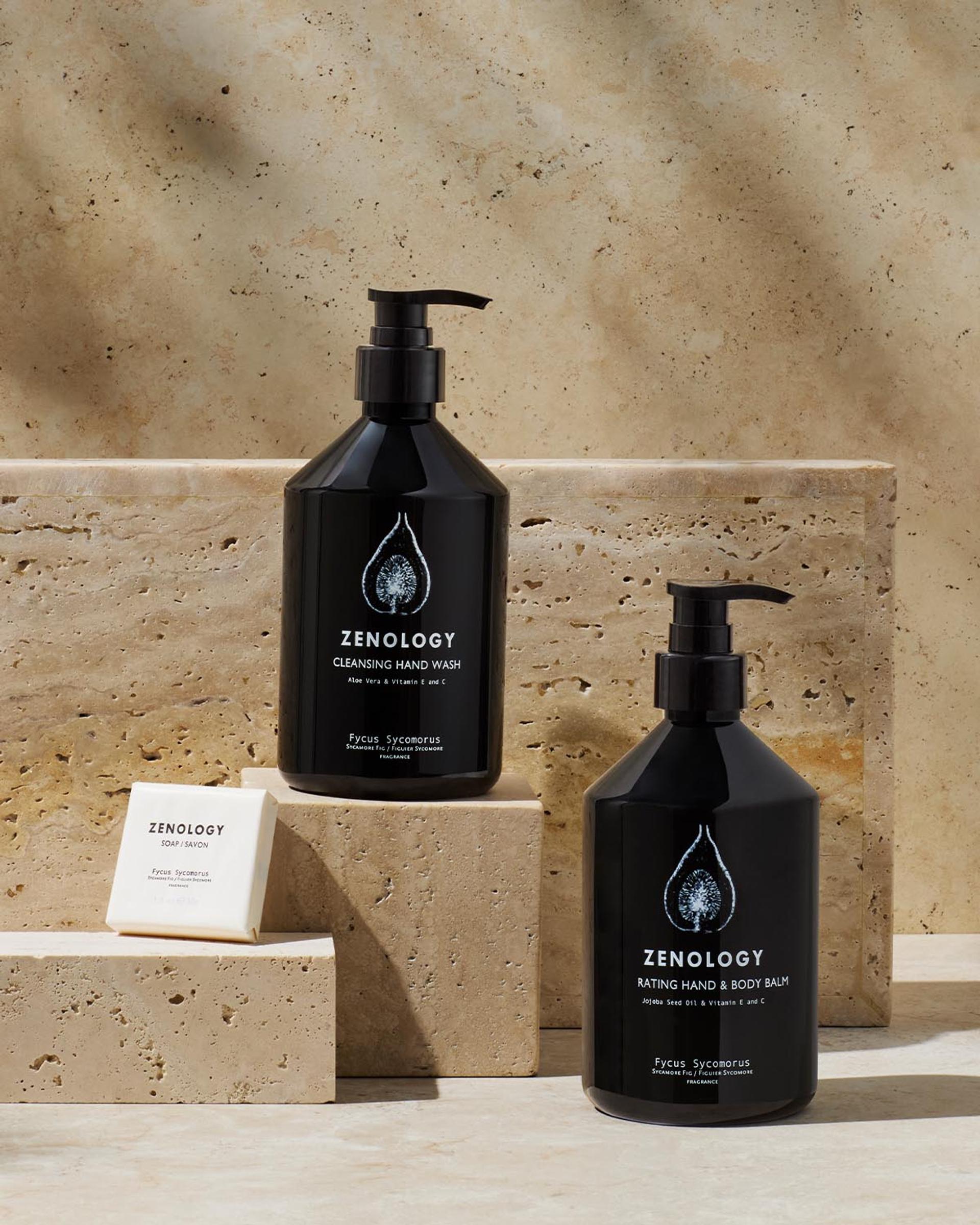 Zenology Sycamore Fig Hand Wash, Body Balm, and Bar Soap on bathroom vanity with stone