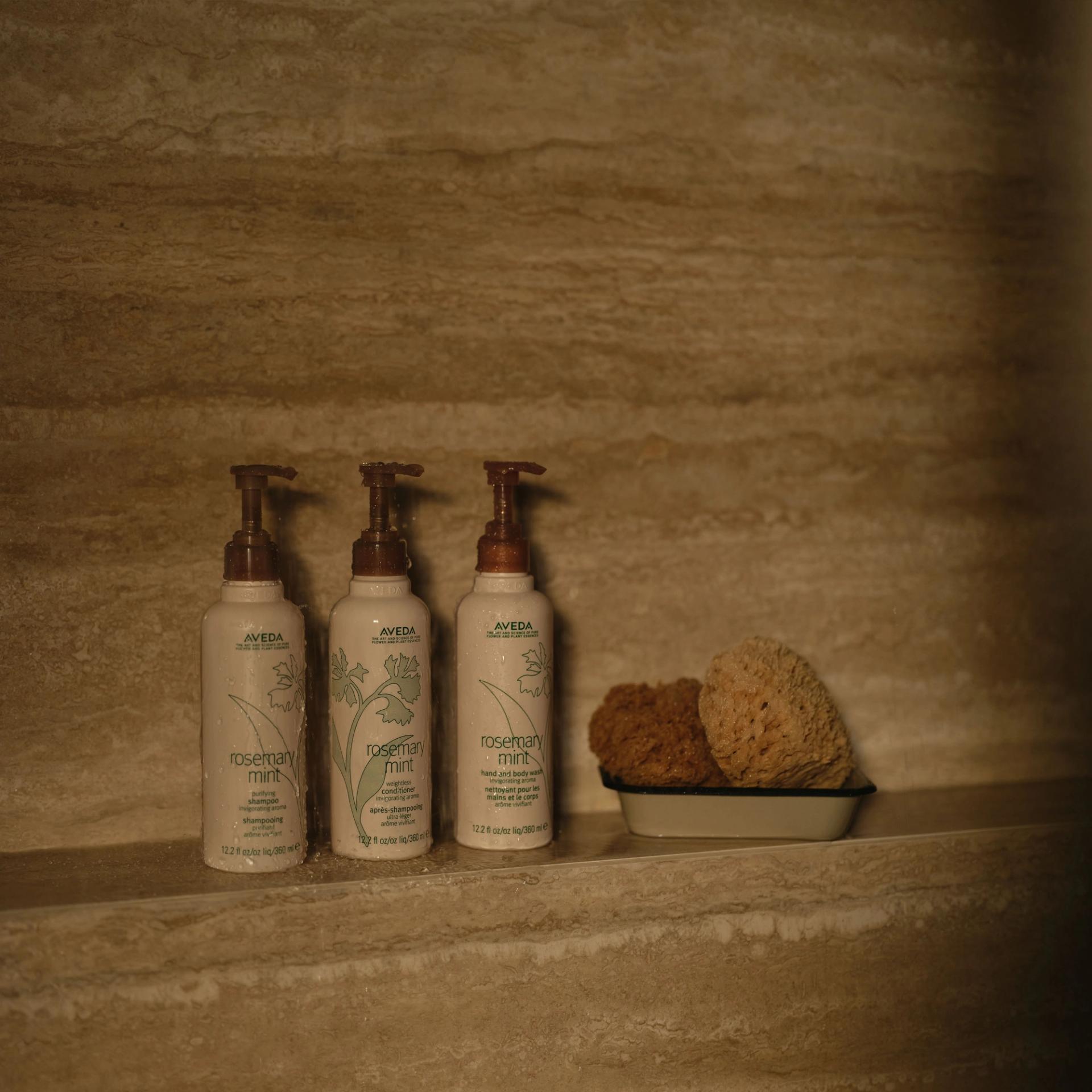 Aveda Shampoo, Conditioner, Body Wash 360ml in the shower.
