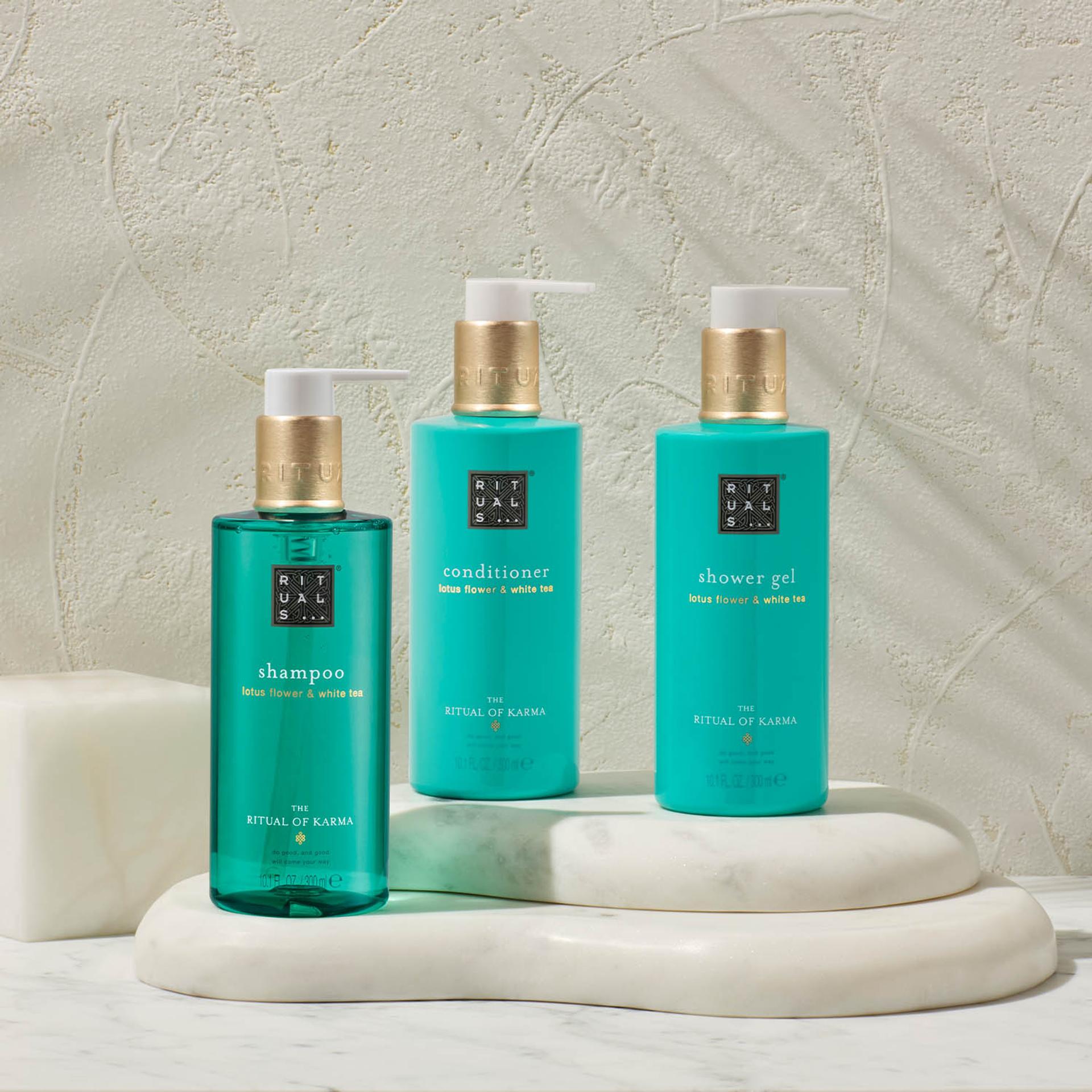Rituals of Karma Shampoo, Conditioner, and Body Wash dispensers on marble