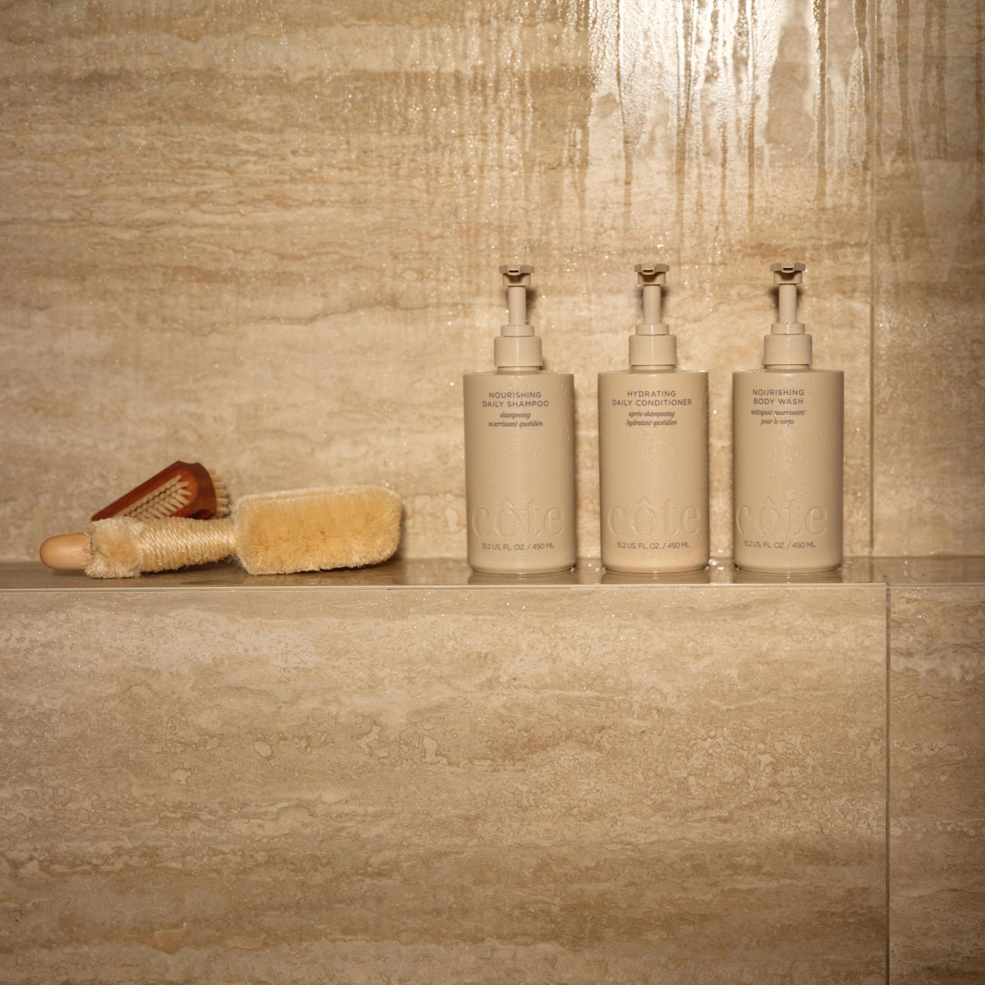 Cote Shampoo, Conditioner, Body Wash in the shower.