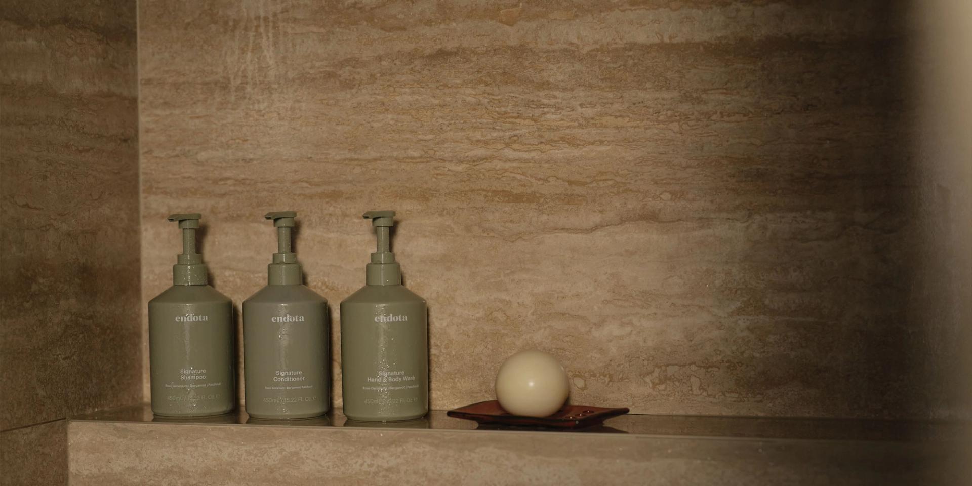 endota Shampoo, Conditioner, Body Wash in the shower.