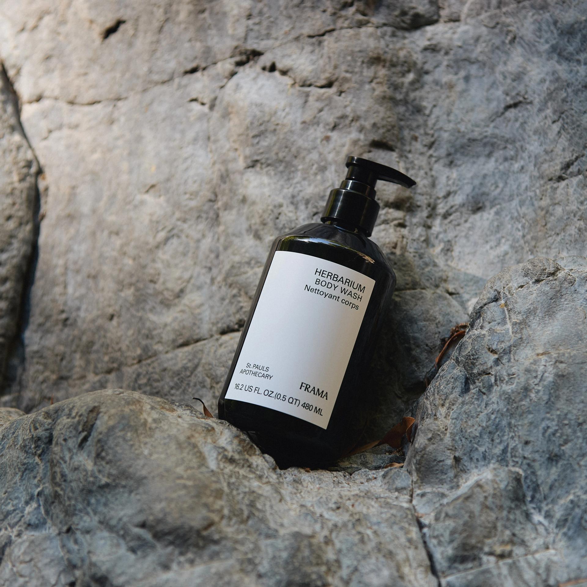 Frama Herbarium Body Wash sitting on rock outdoors