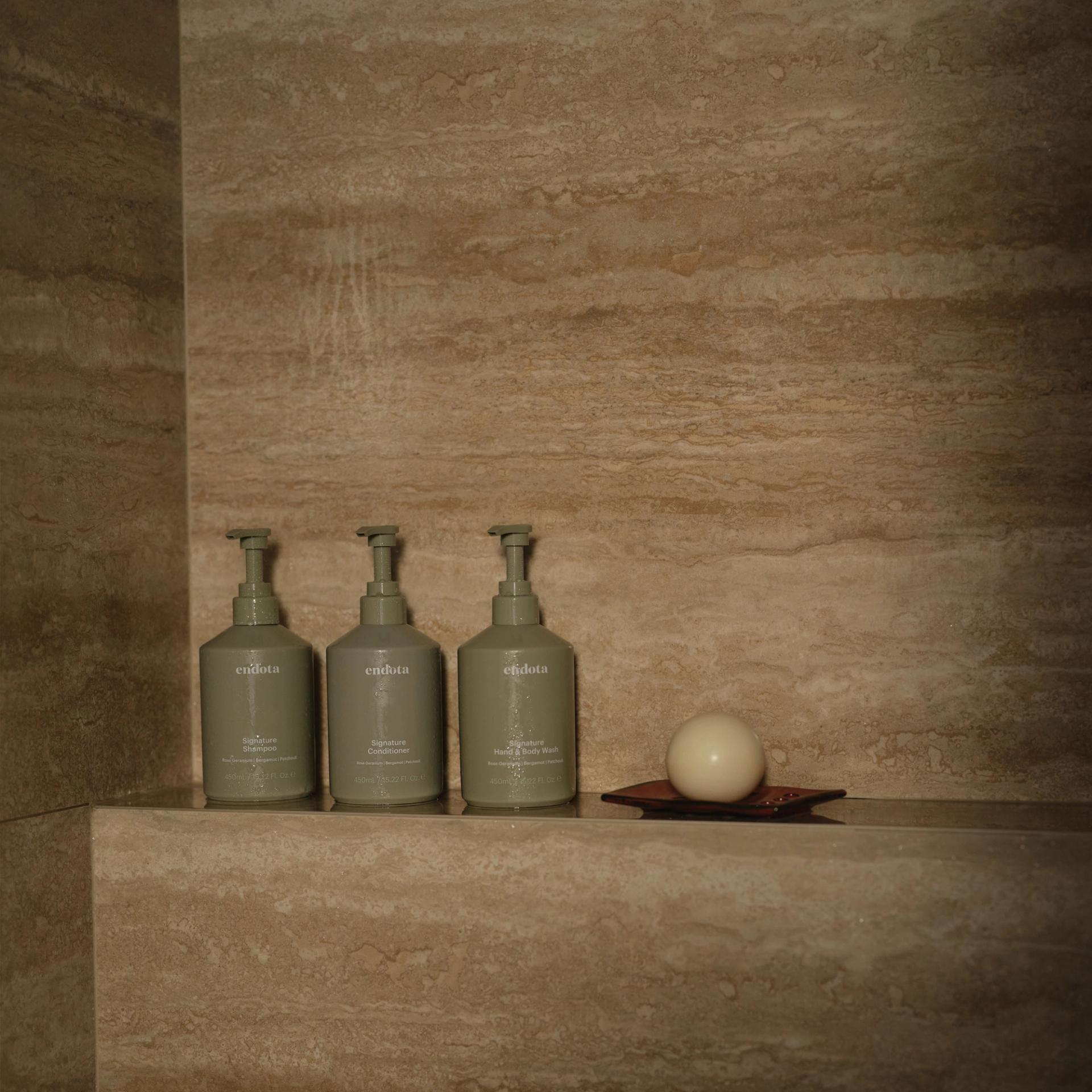 endota Shampoo, Conditioner, Body Wash in the shower.