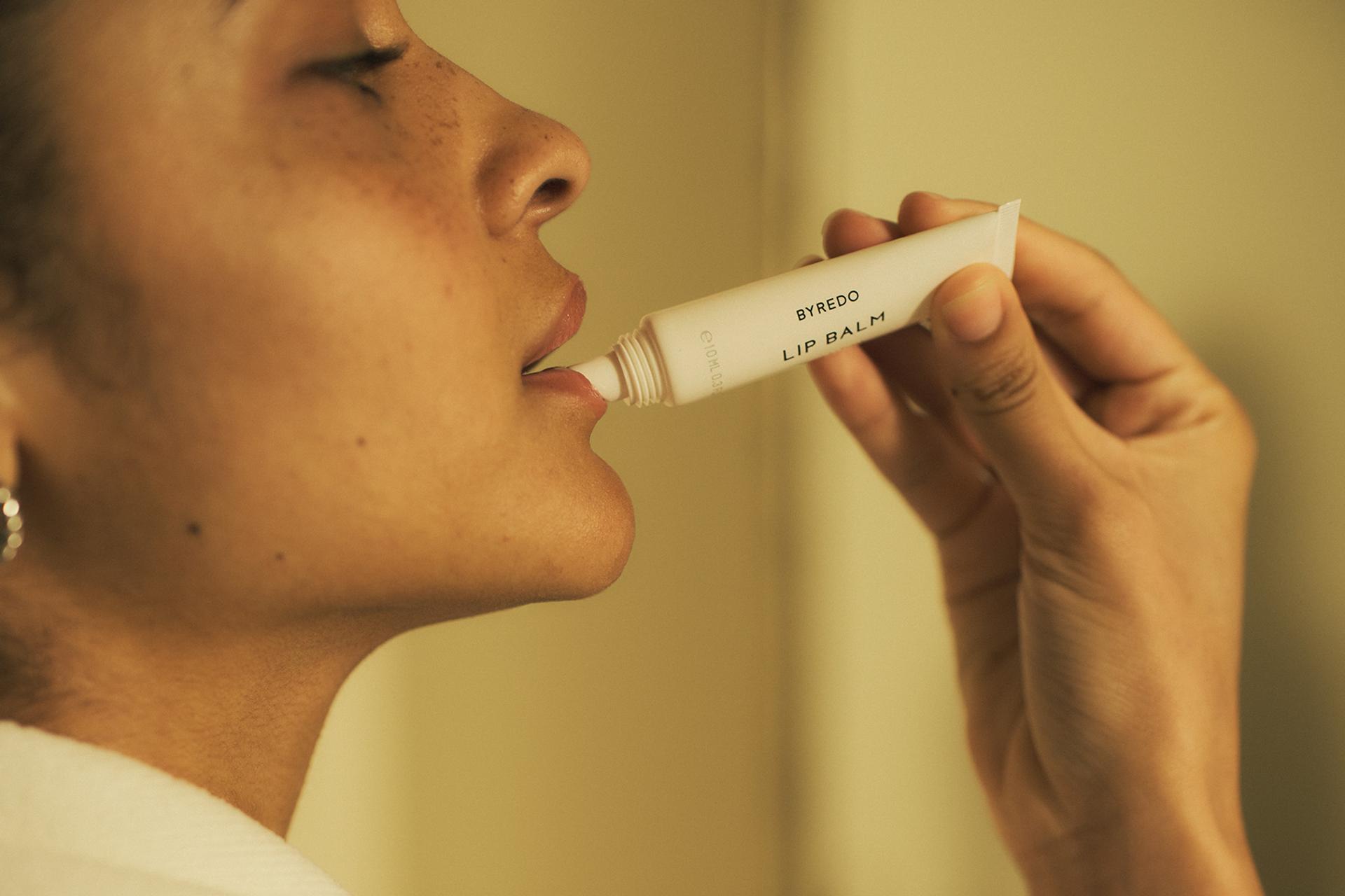 Girl applying Byredo Lip Balm