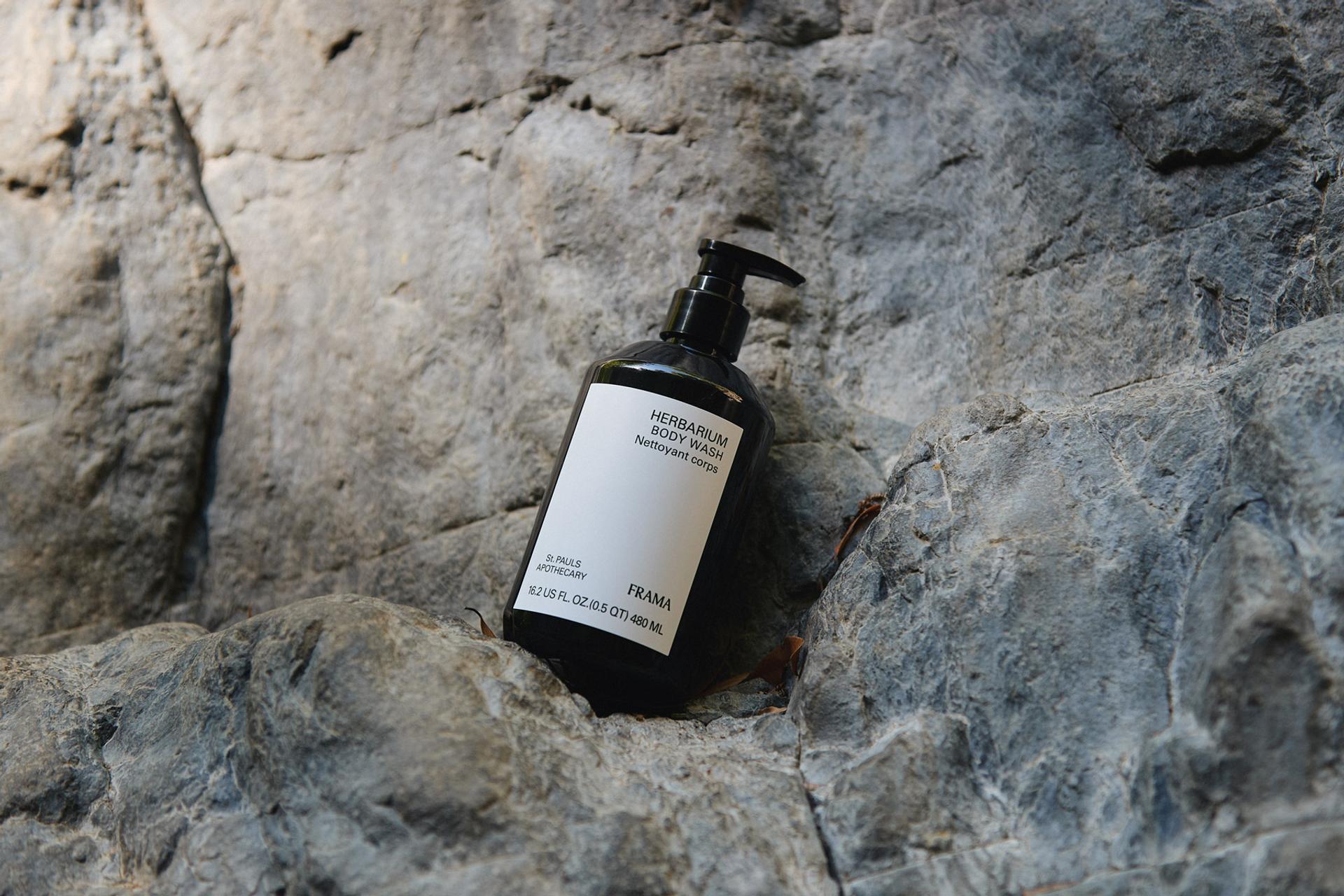 Frama Herbarium Body Wash sitting on rock outdoors