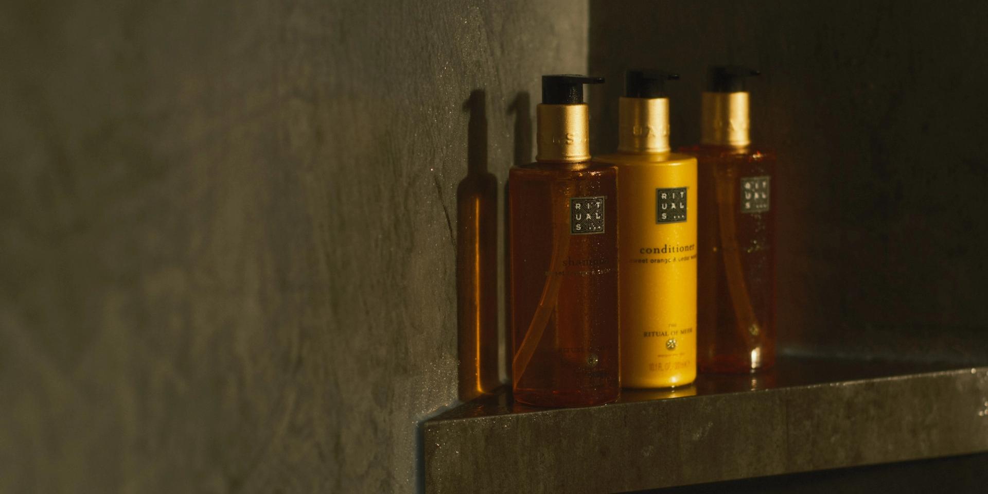 Rituals of Mehr Shampoo, Conditioner, and Body Wash dispensers on shower shelf
