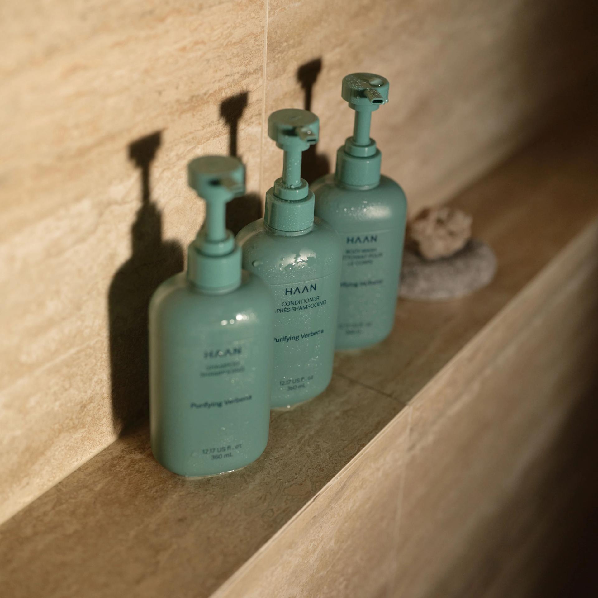 Haan Shampoo, Conditioner, Body Wash in the shower.