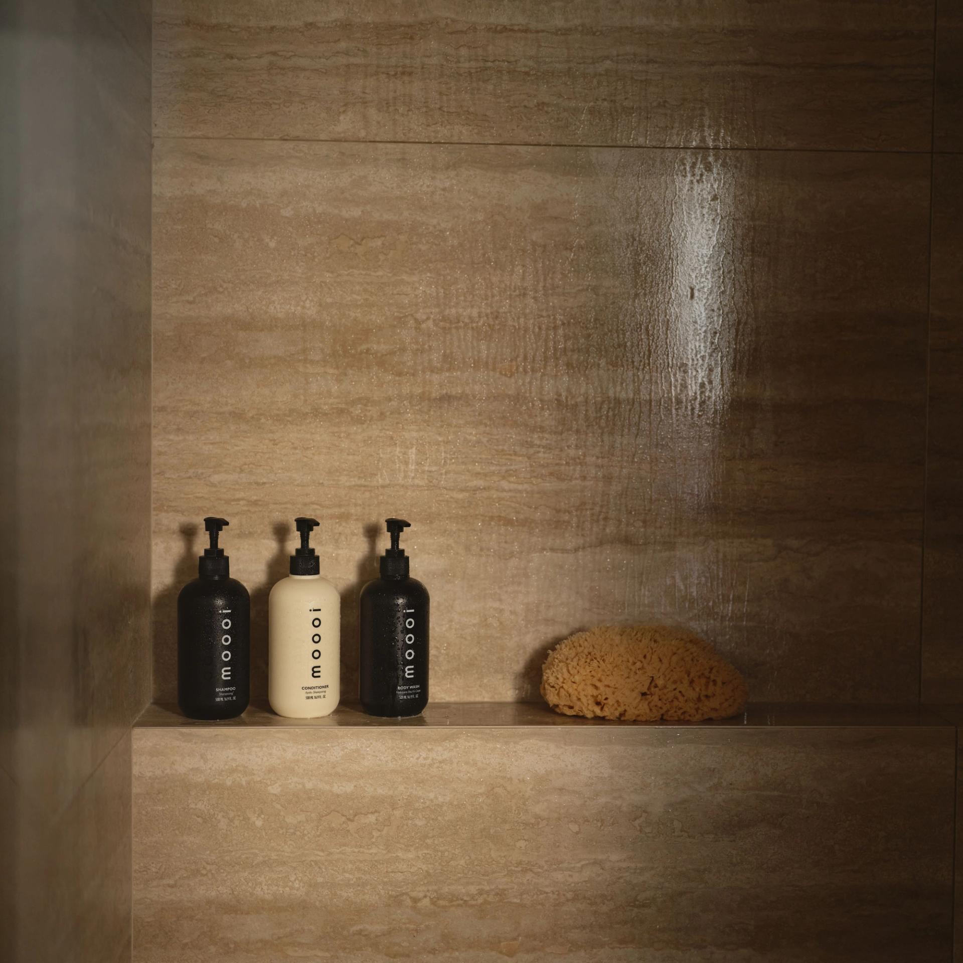 Moooi Shampoo, Conditioner, Body Wash in the shower.