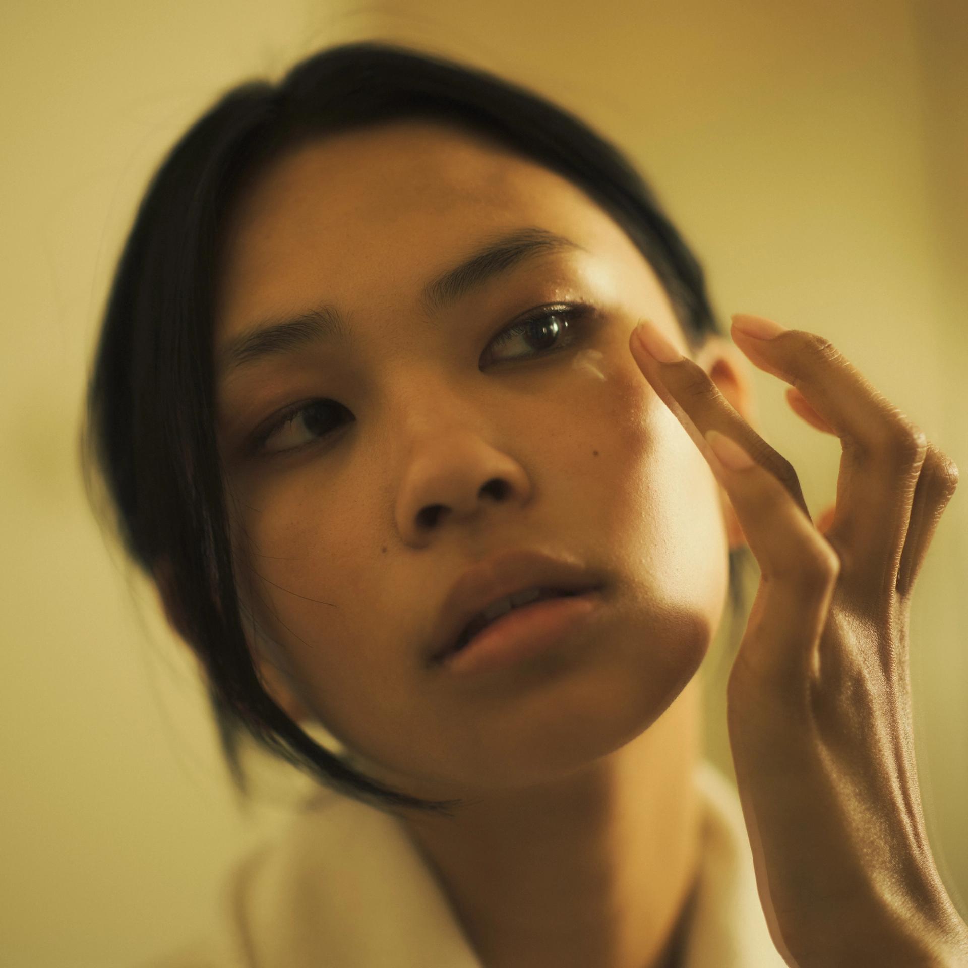 Girl applying eye cream