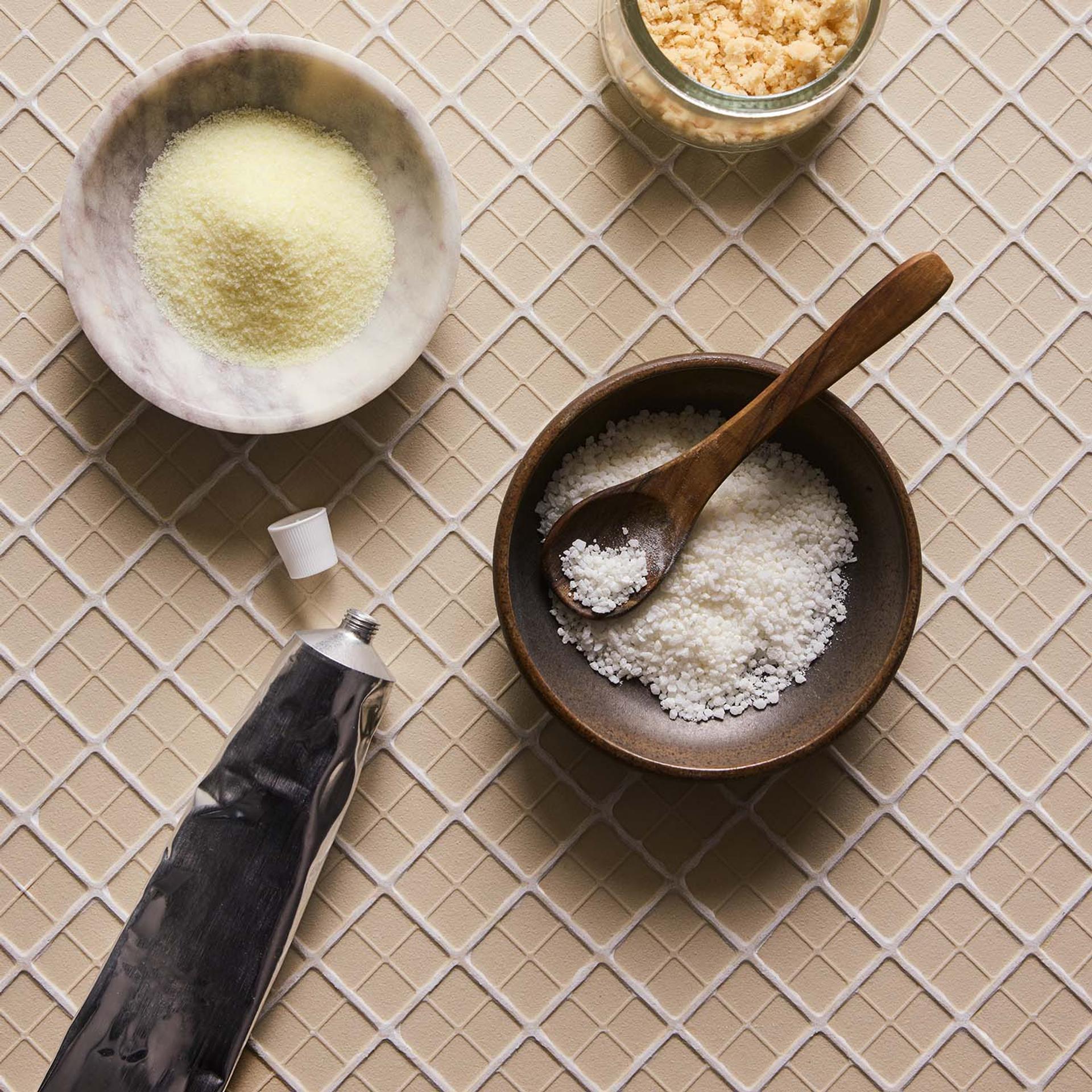 Bath products and aluminum packaging displayed on tile surface