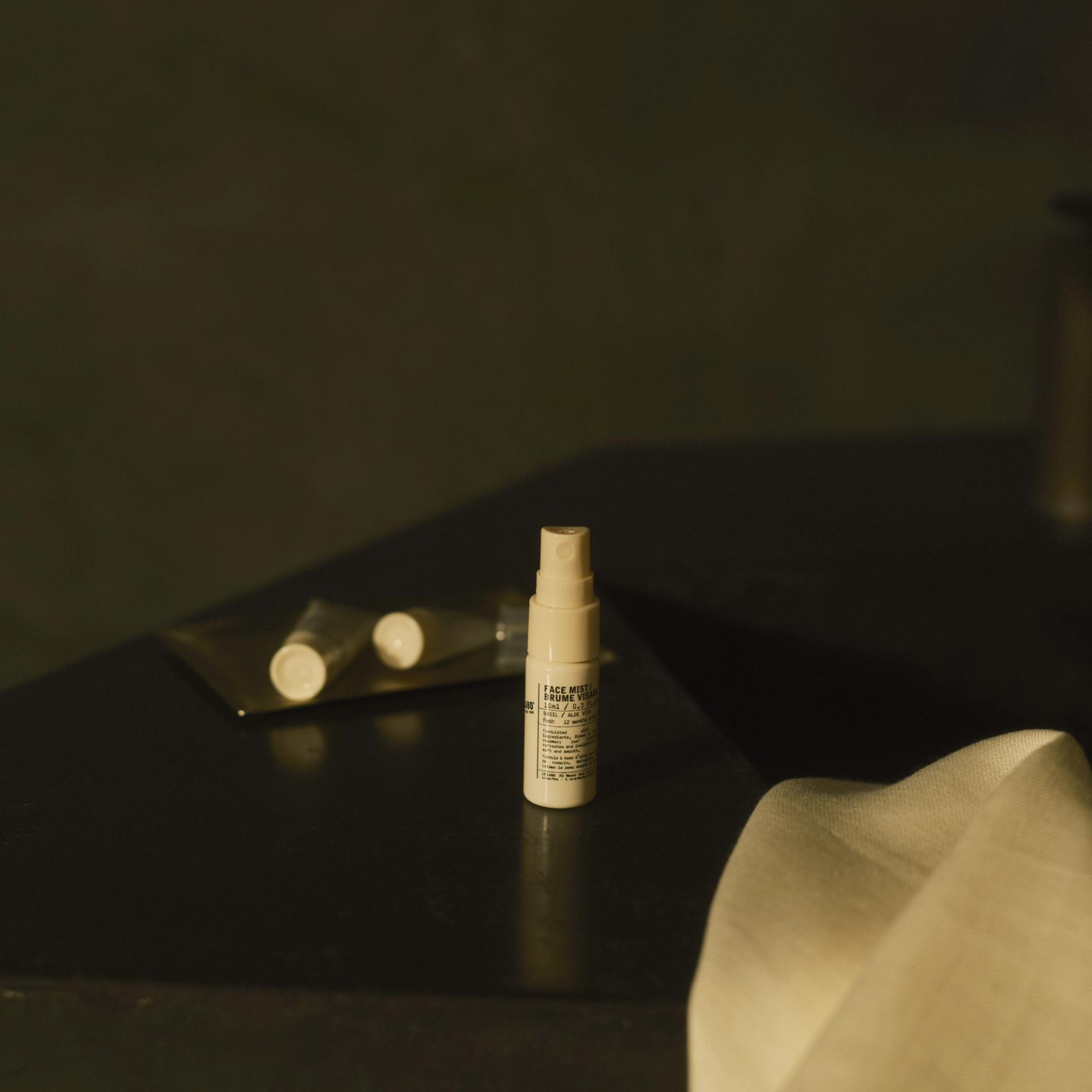 Le Labo Basil Face Mist and Hand Pomade and Lip Balm on bathroom vanity