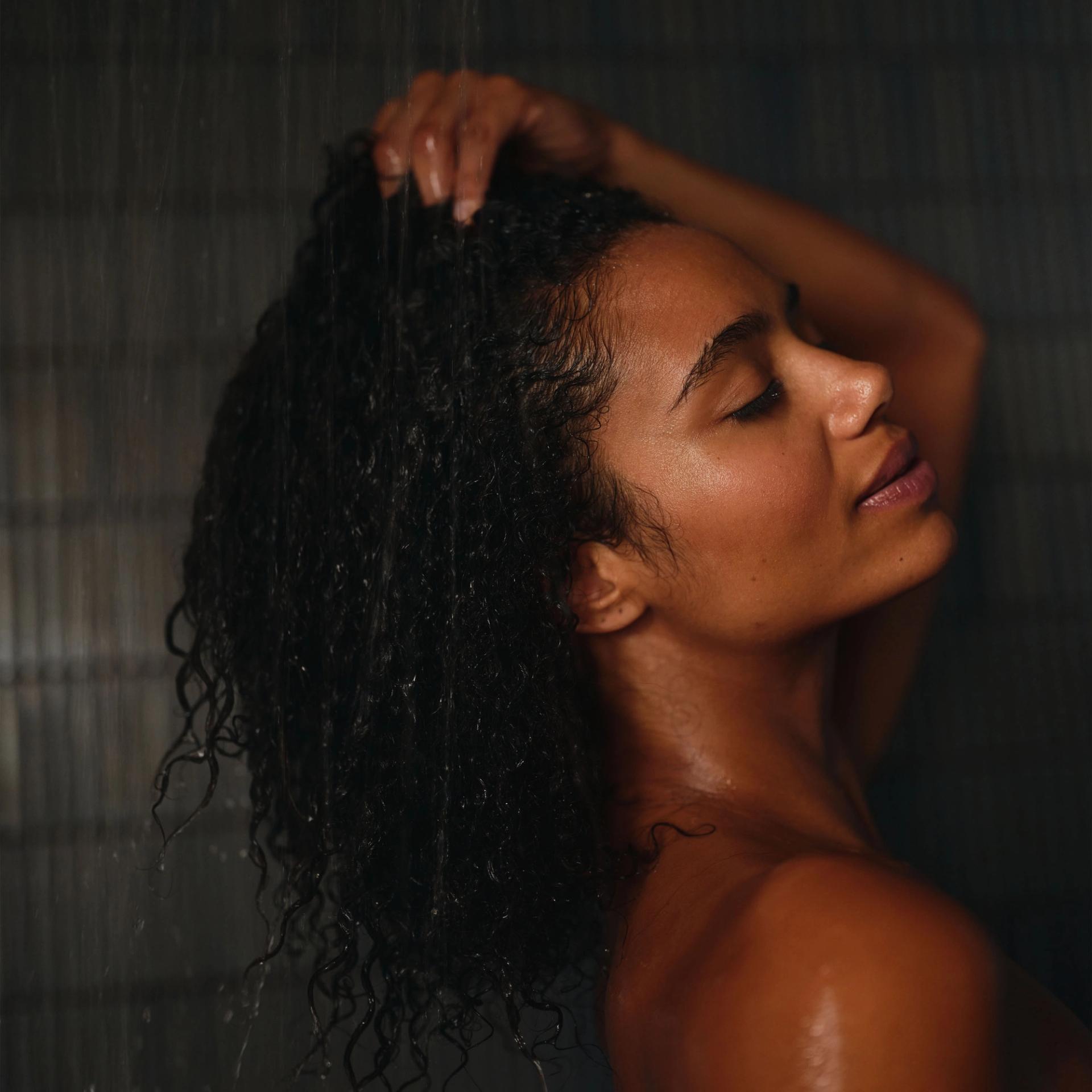 Model washing hair.