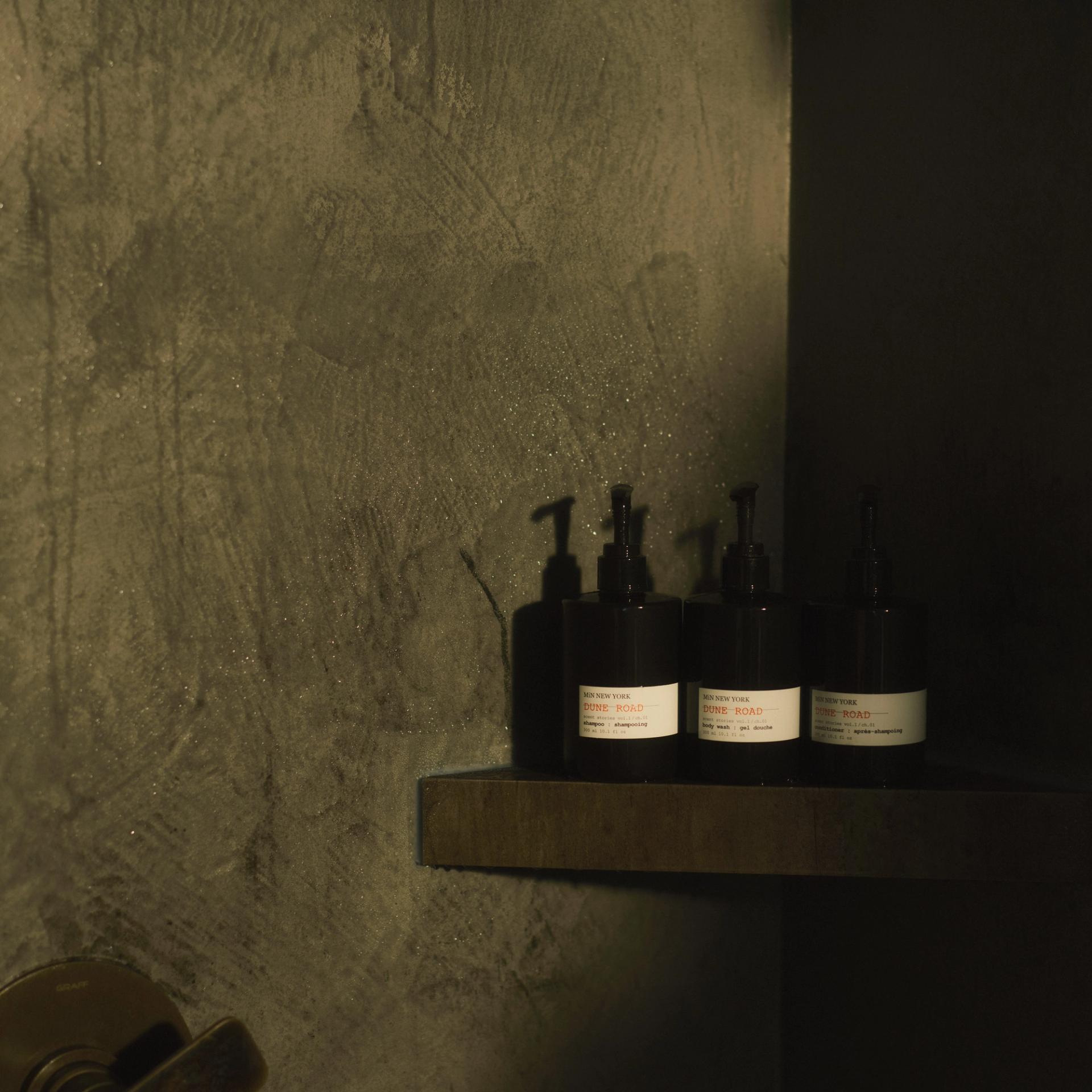 MiN New York Dune Road Shampoo, Conditioner and Body Wash dispensers on shower shelf