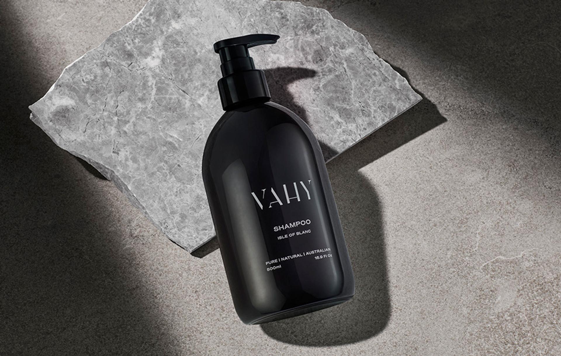 Vahy Isle of Blance Shampoo dispenser laying flat on stone bathroom vanity