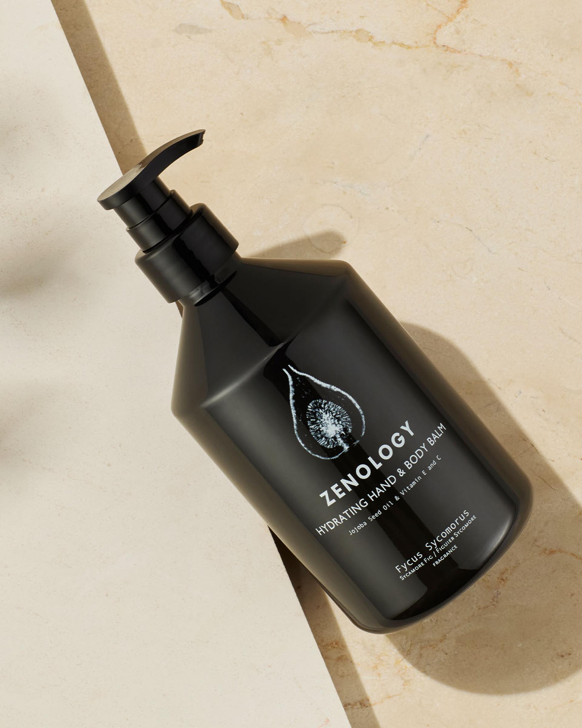 Zenology Sycamore Fig Hand and Body Balm bottle laying flat on bathroom vanity