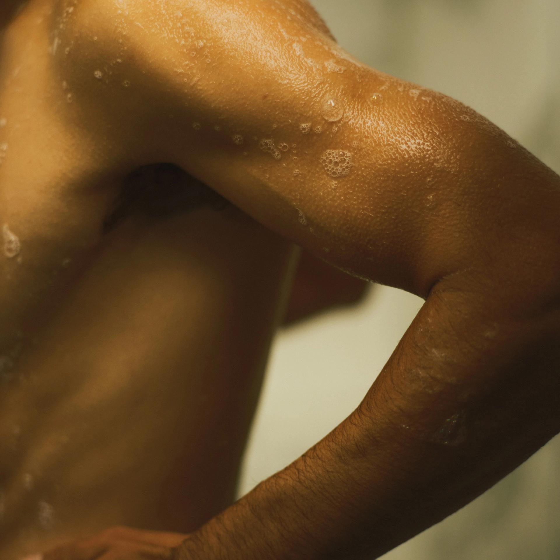 Guy in shower with soap lather