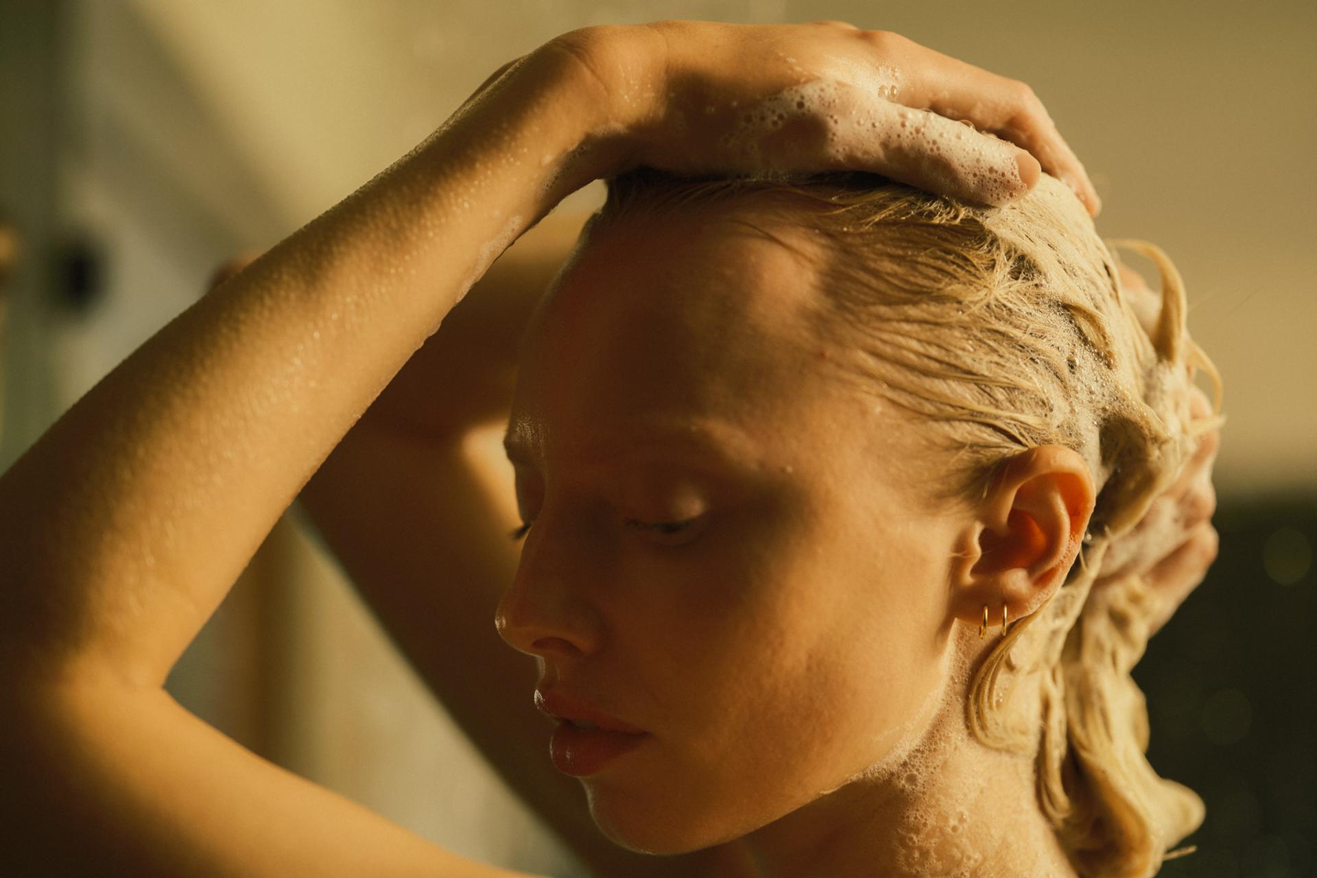 Girl in shower lathering hair