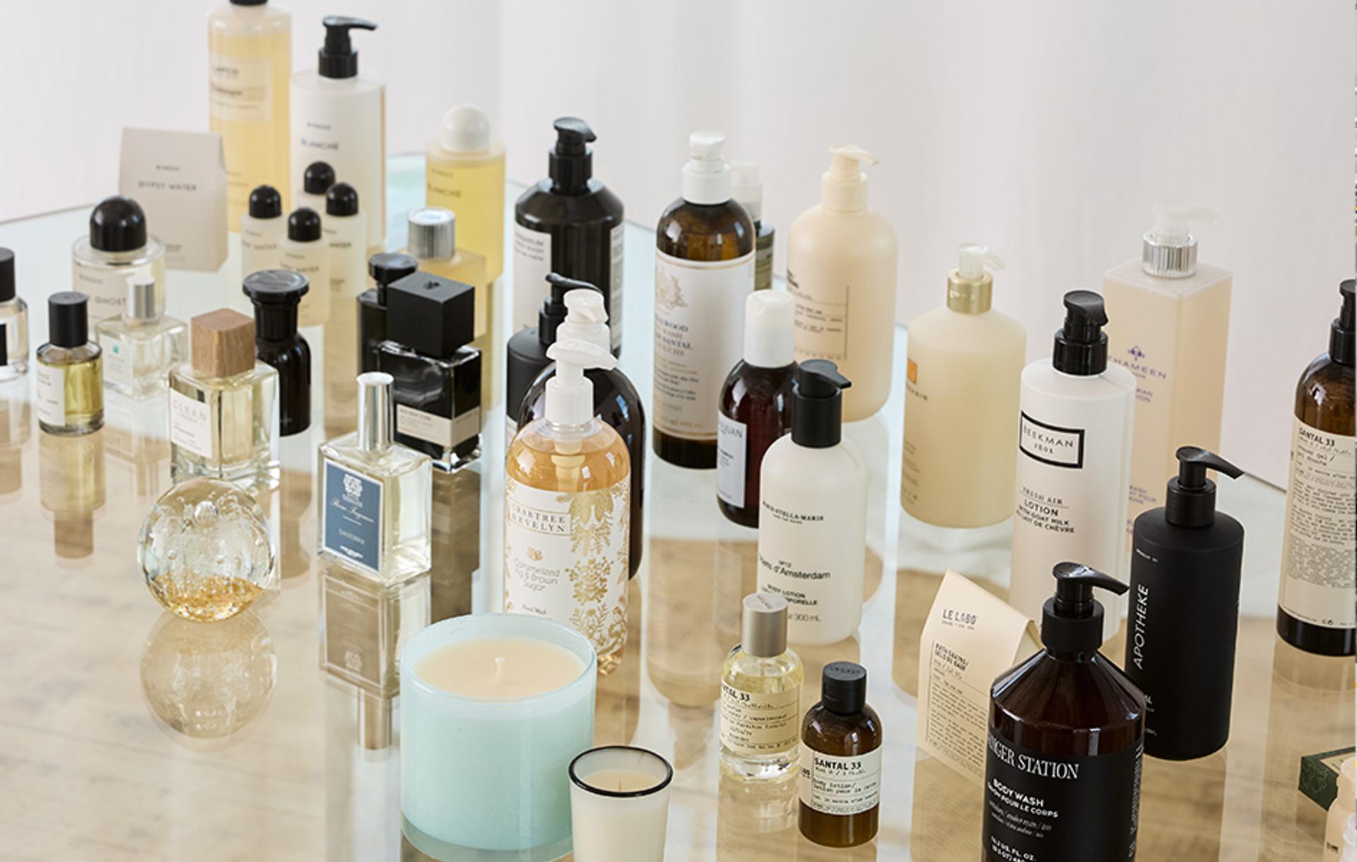 Cosmetic and perfume products displayed on glass table