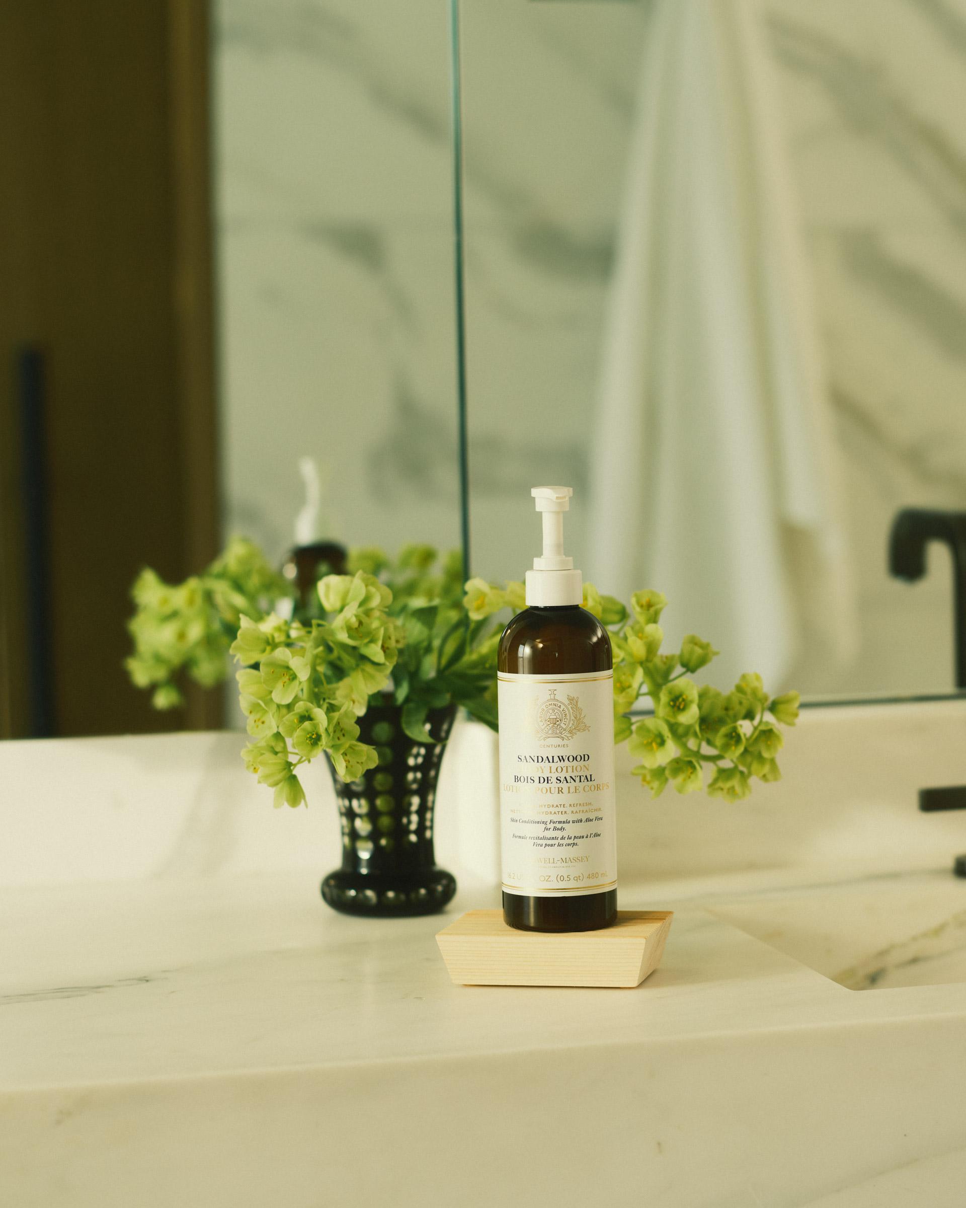 Bottle of Caswell-Massey Sandalwood Body Lotion sitting on bathroom countertop