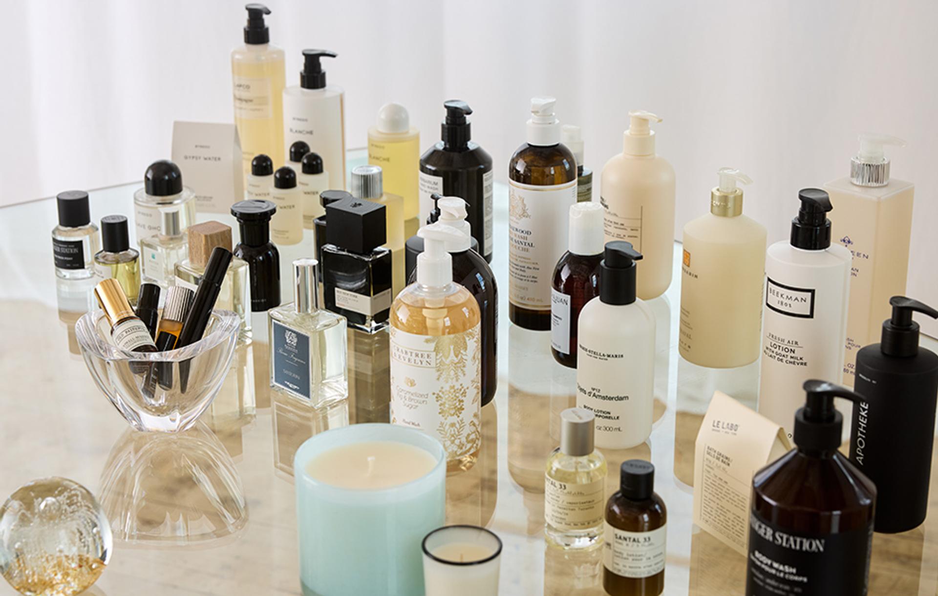 Cosmetic and perfume products displayed on glass table