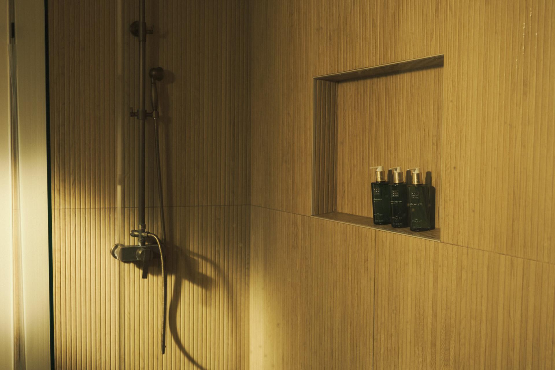 Rituals of Jing Shampoo, Conditioner, and Body Wash dispensers on shower shelf