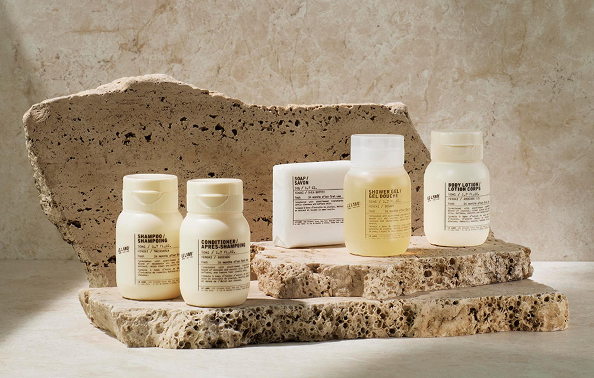 Le Labo Hinoki Shampoo, Conditioner, Body Wash, Body Lotion and Bar Soap single-use amenities on counter