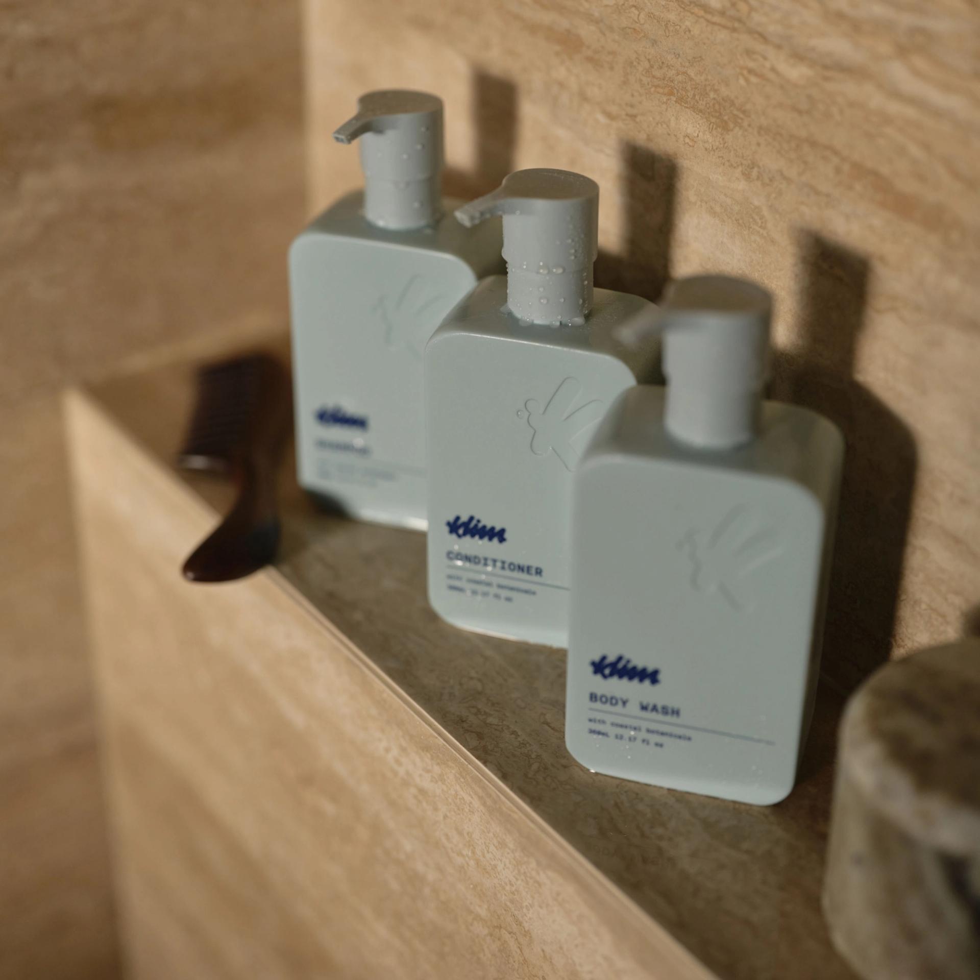 Klima Shampoo, Conditioner, Body Wash in shower settings.