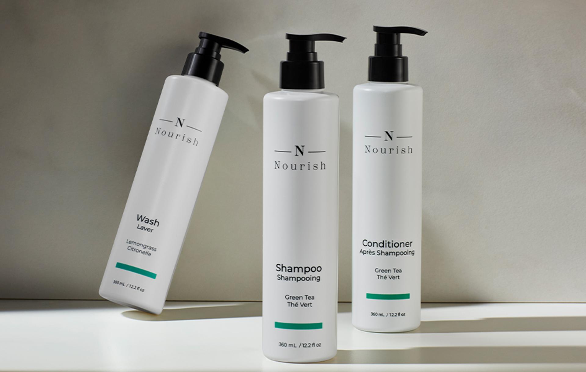 Nourish Shampoo, Conditioner, and Body Wash dispensers on counter