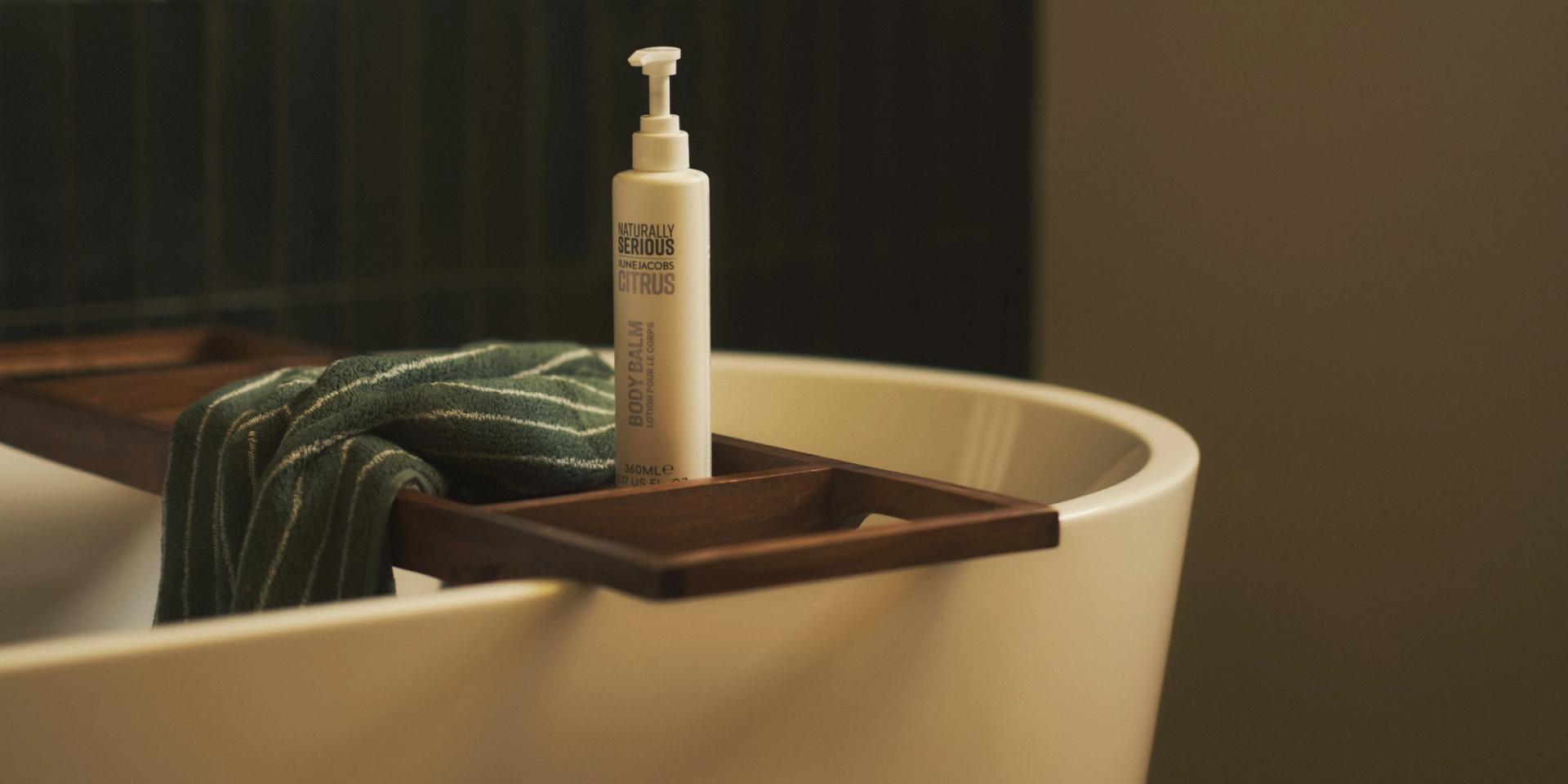 Naturally Serious Skincare Citrus Body Lotion on bath tub caddy