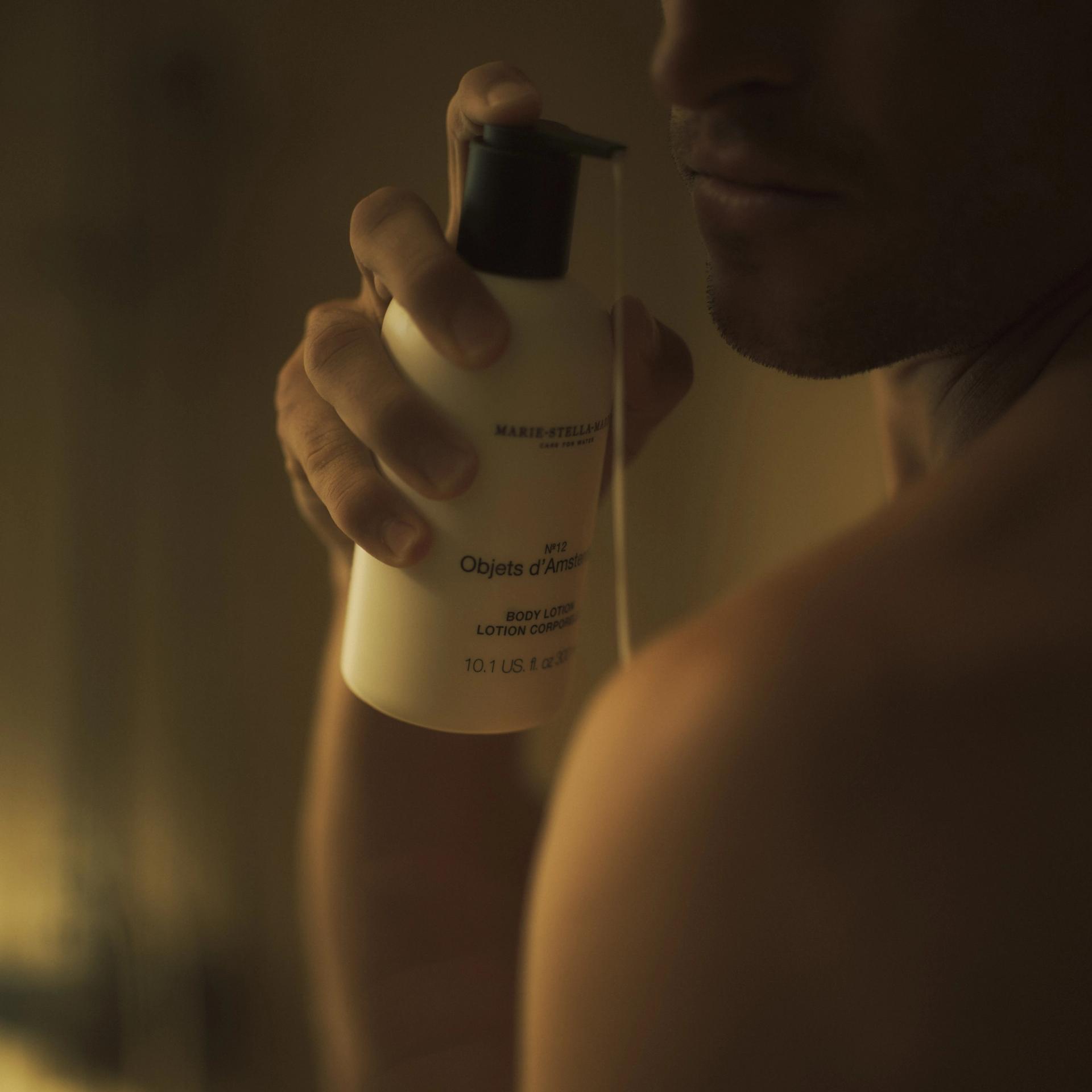 Man in shower using Marie Stella Maris Objets d'Amsterdam Body Lotion on body