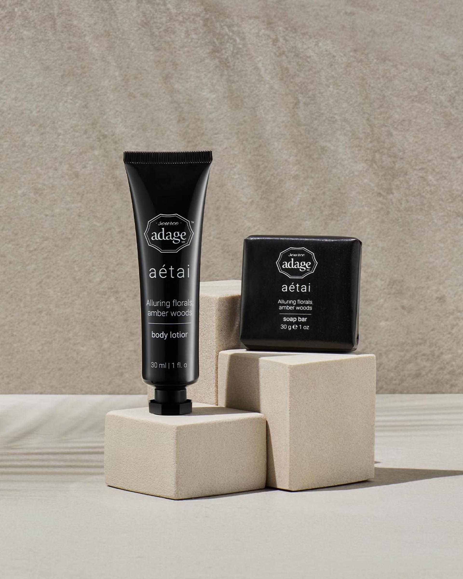 Source Adage Aetai Body Lotion tube and soap bar on bathroom vanity