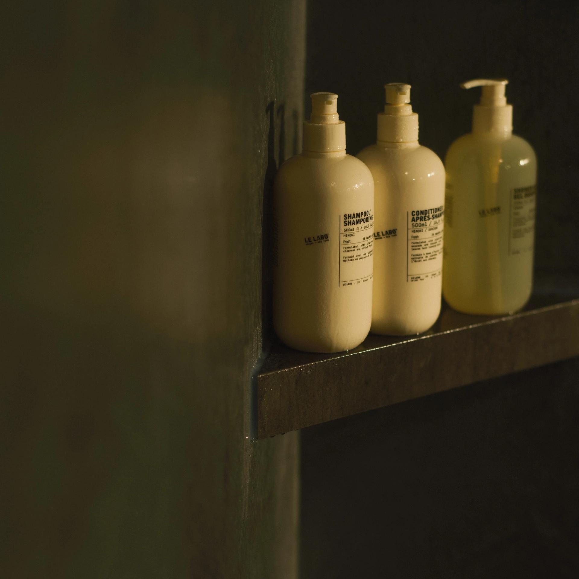 Labo Hinoki Shampoo, Conditioner and Shower Gel dispensers on shower shelf