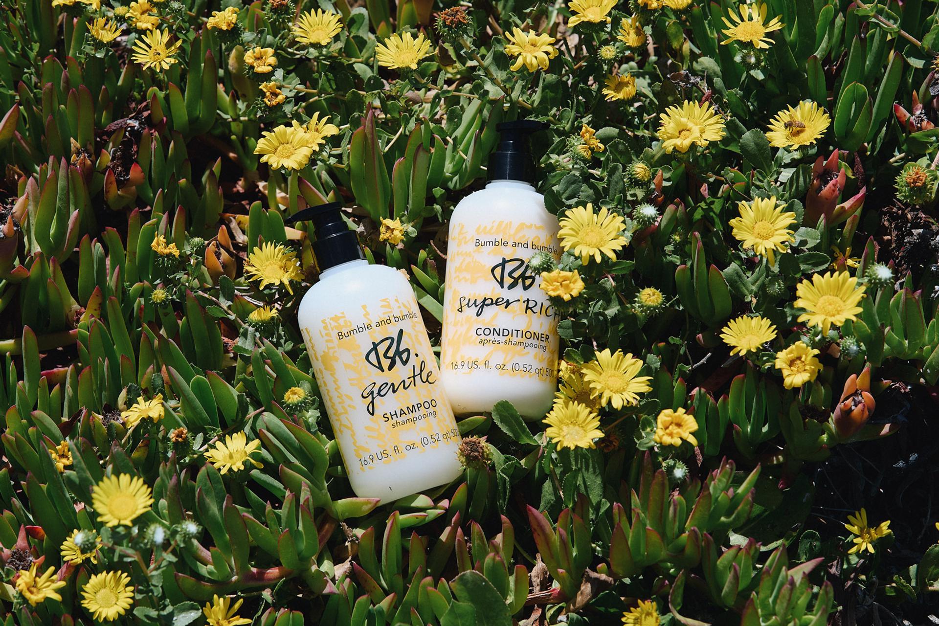 Bumble & Bumble Shampoo and Conditioner photographed in a bed of flowers