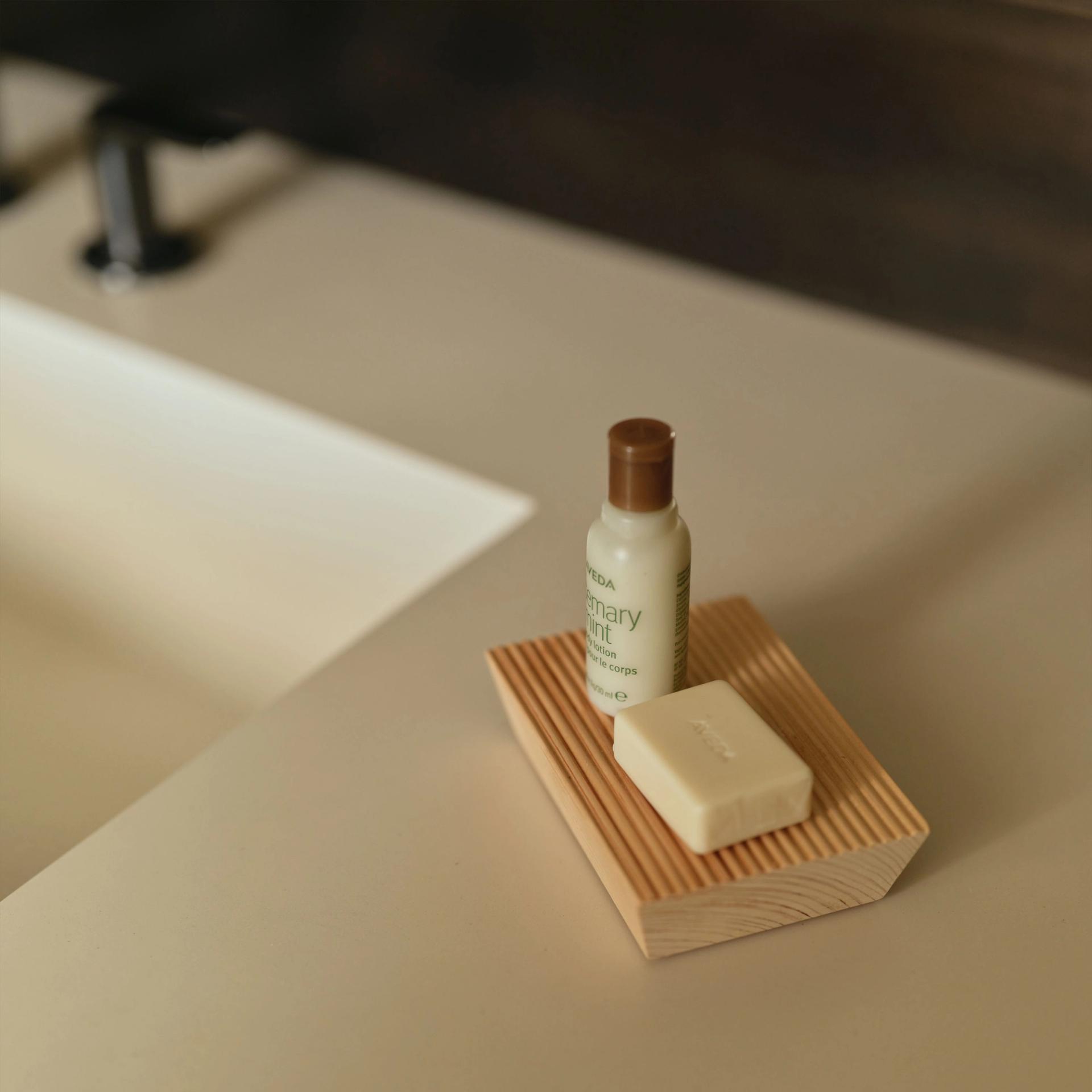 Aveda mini Body Lotion and Soap Bar on vanity side.
