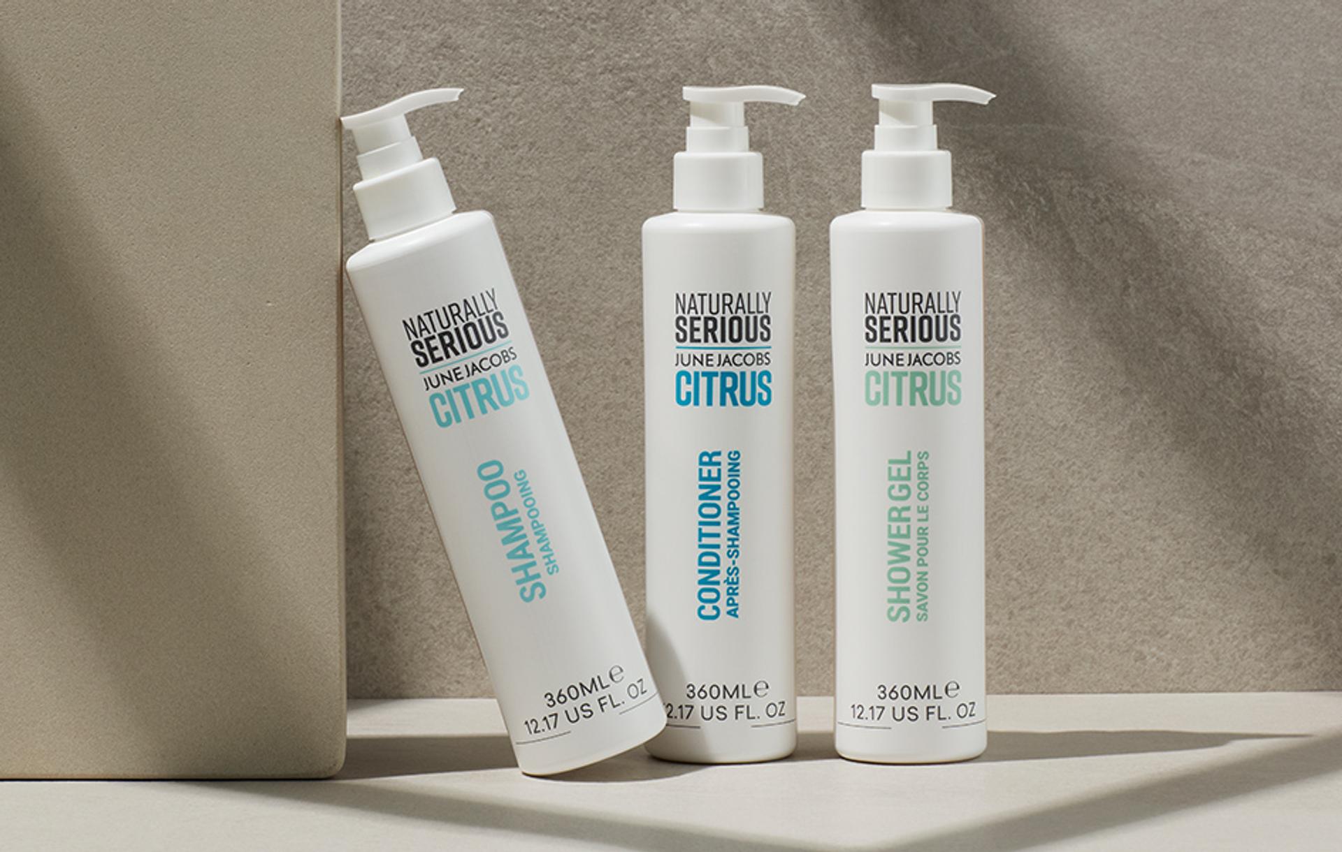 Naturally Serious Skincare Citrus Shampoo, Conditioner, and Body Wash dispensers on counter