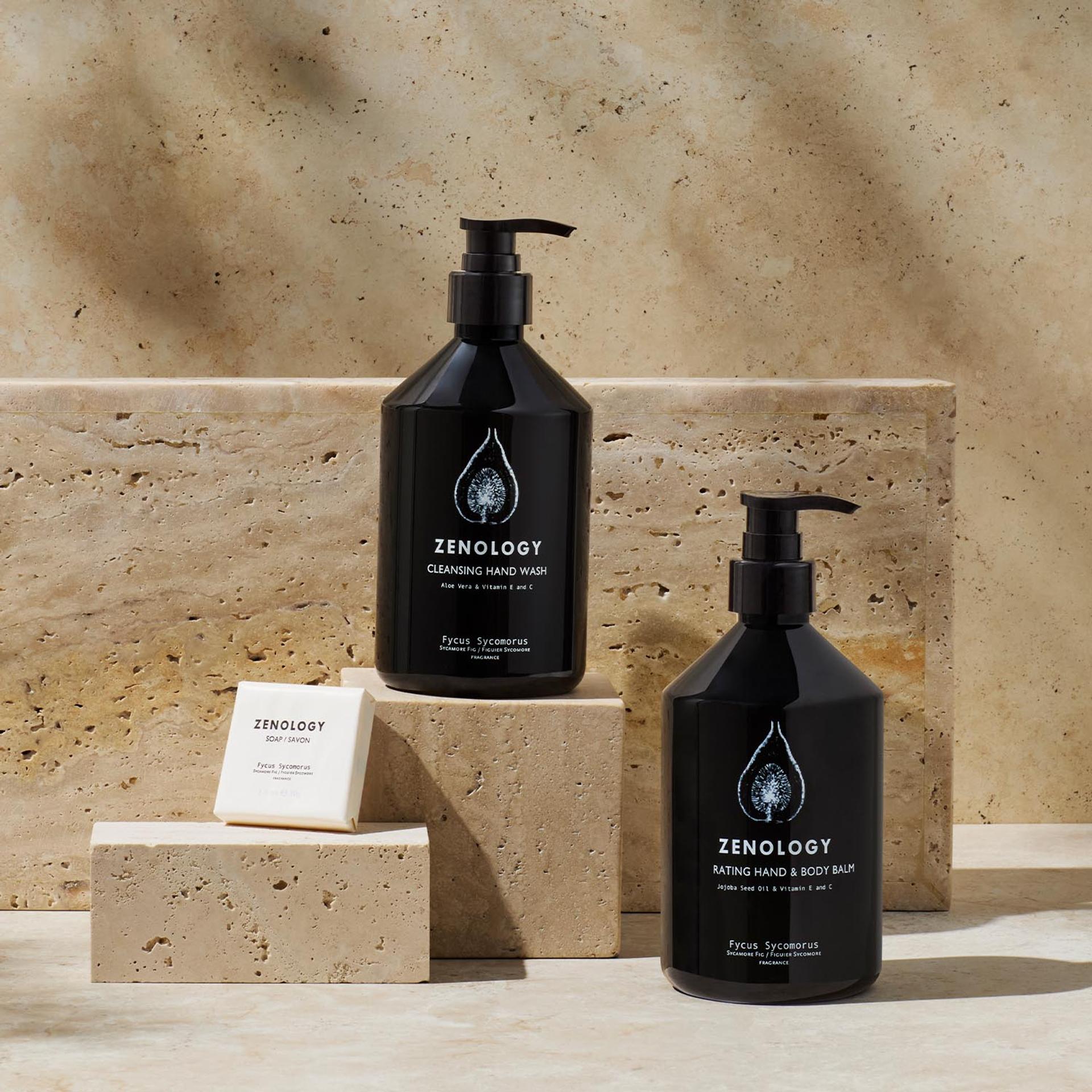 Zenology Sycamore Fig Hand Wash, Body Balm, and Bar Soap on bathroom vanity with stone