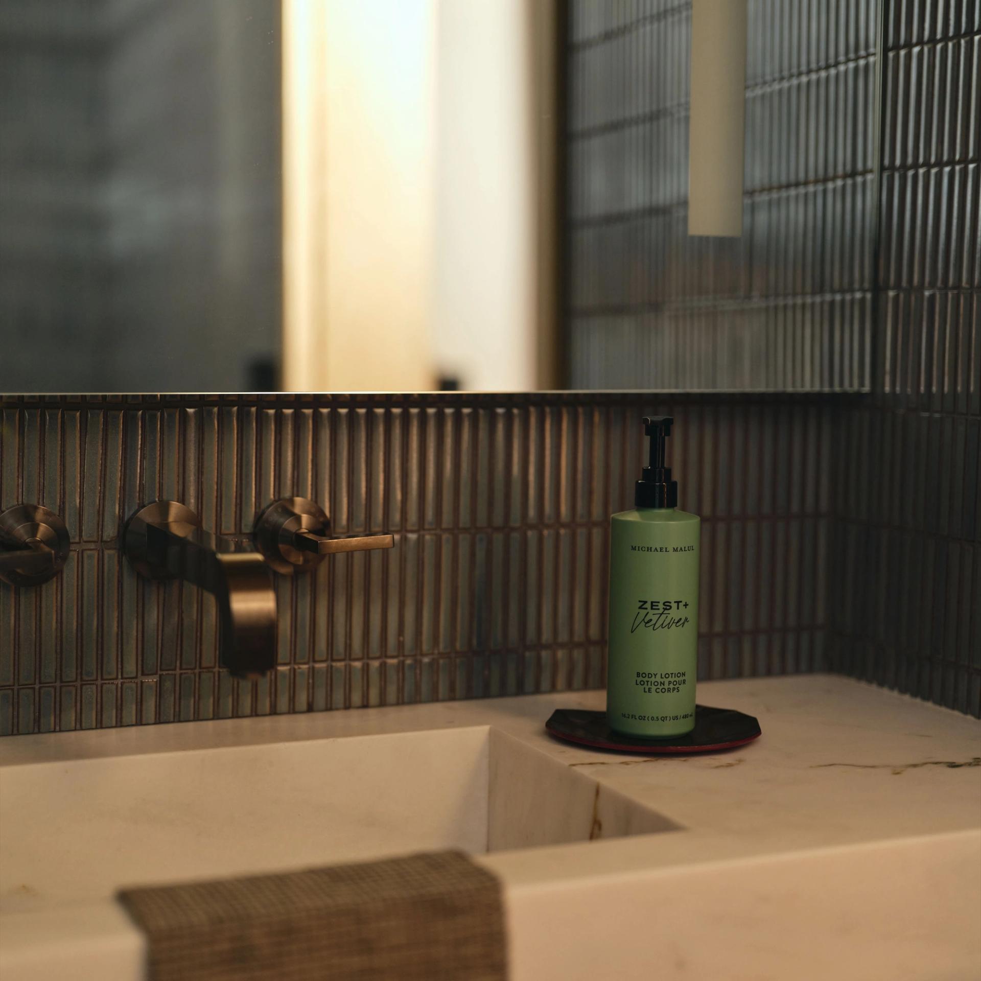 Michael Malul Body Lotion 480ml dispensers on the vanity side.