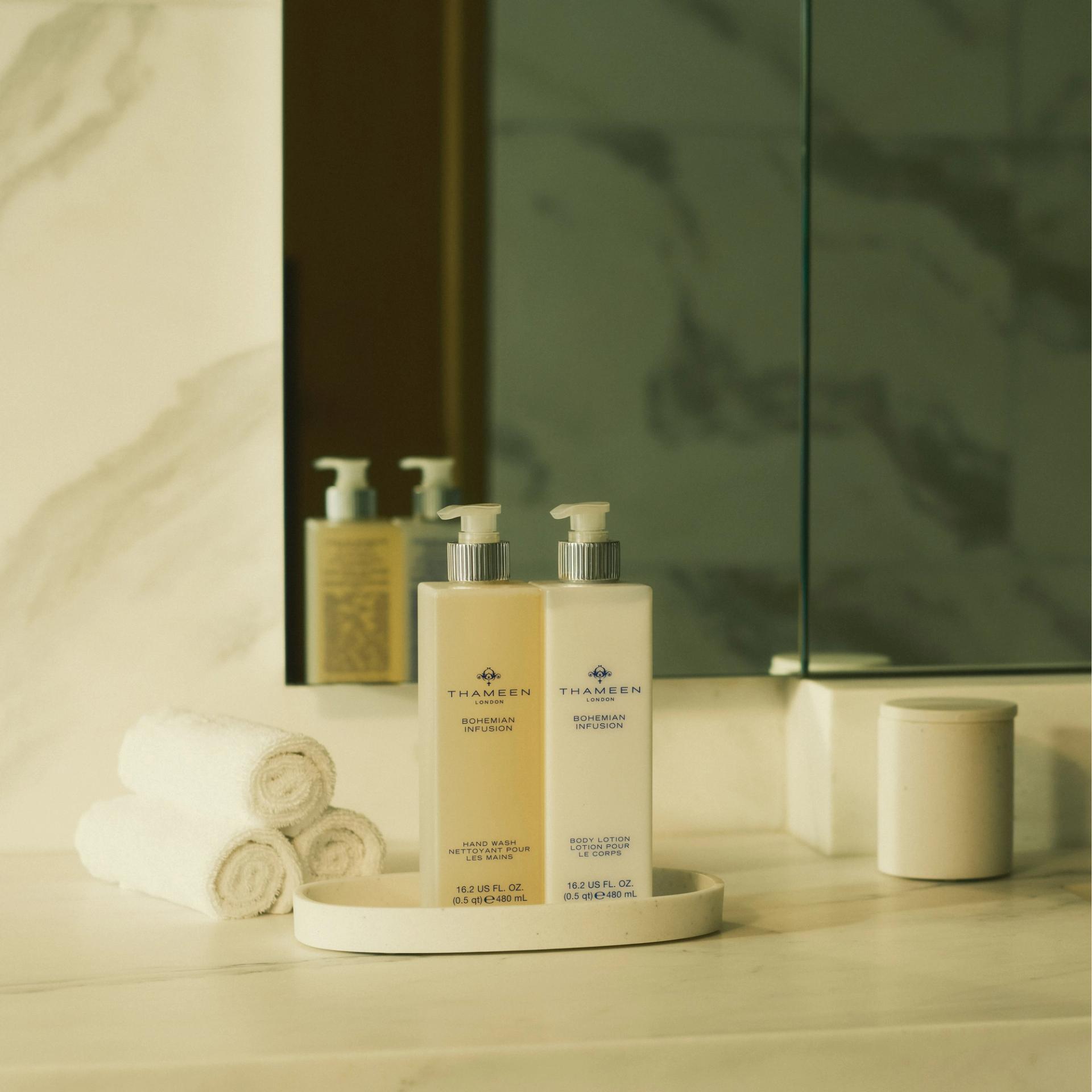 Thameen London Bohemian Infusion Hand Wash and Body Lotion dispensers on marble bathroom vanity