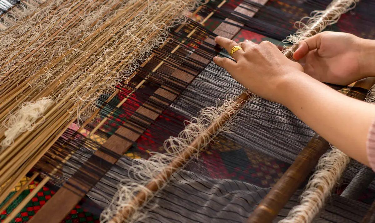 Hands of a woman weaving